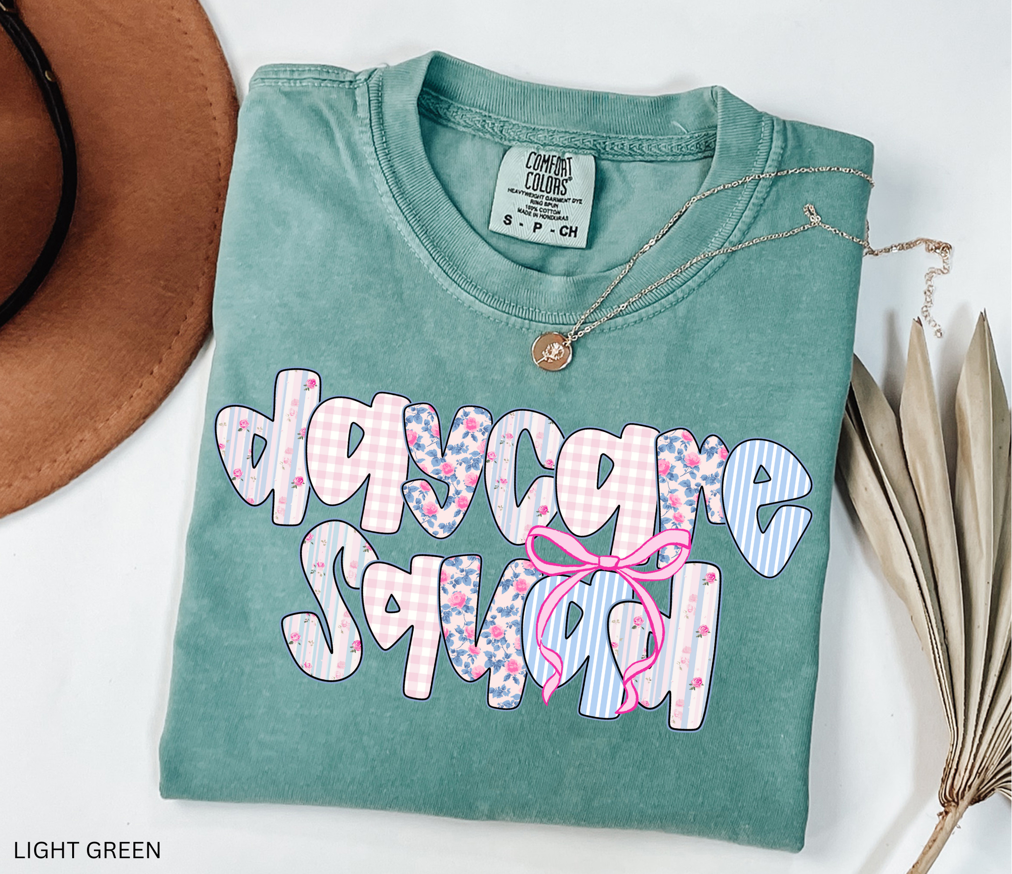 Daycare Squad shirt with floral patterns and pink bow design – teacher team apparel