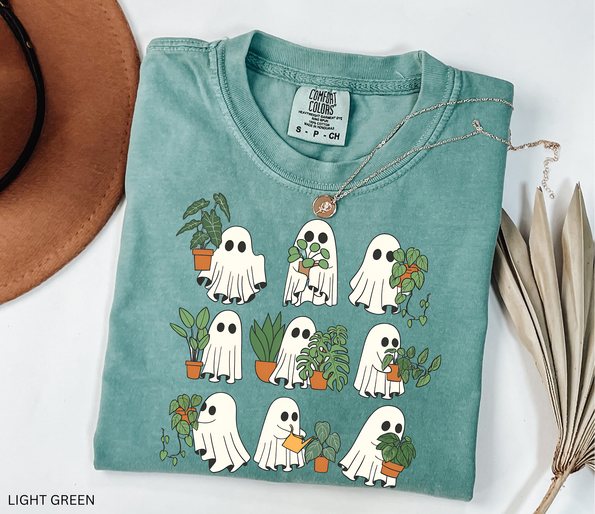 Ghost plant lover shirt with multiple spooky ghosts holding different houseplants on a Comfort Colors tee. Cute Halloween botanical design.
