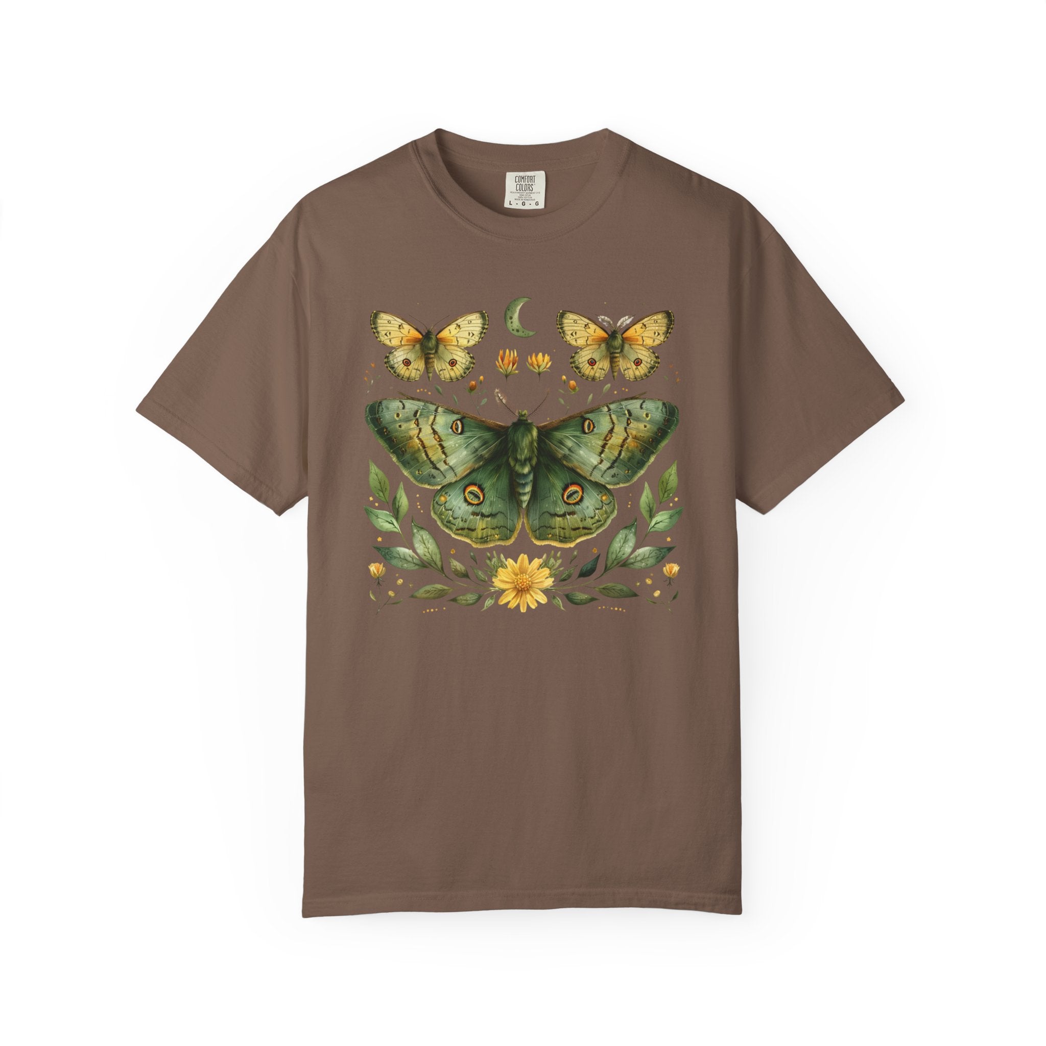 Comfort Colors graphic t-shirt featuring a detailed green luna moth surrounded by wildflowers, leaves, smaller moths, and a crescent moon in a vintage botanical cottagecore illustration