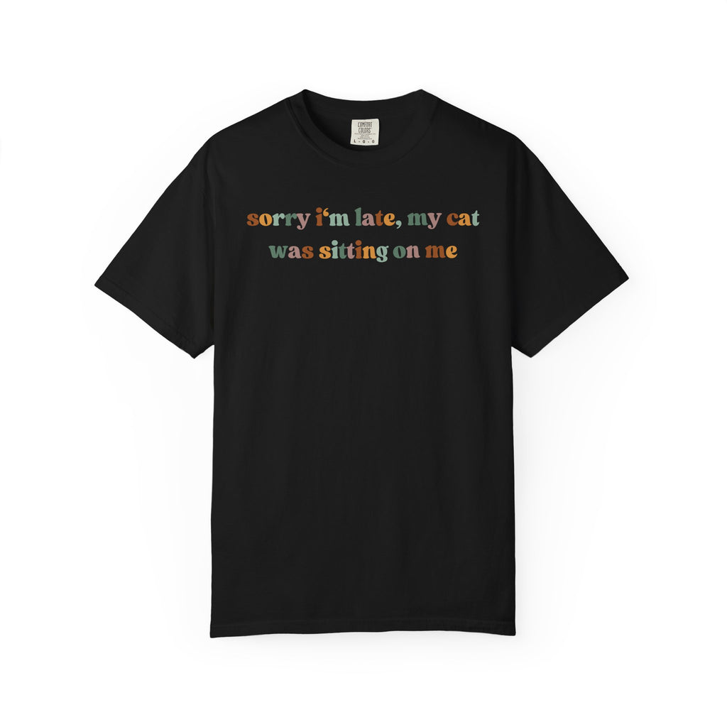 Funny cat lover graphic t-shirt featuring the colorful quote "Sorry I'm Late, My Cat Was Sitting on Me." A humorous gift for cat moms, cat dads, and pet owners.