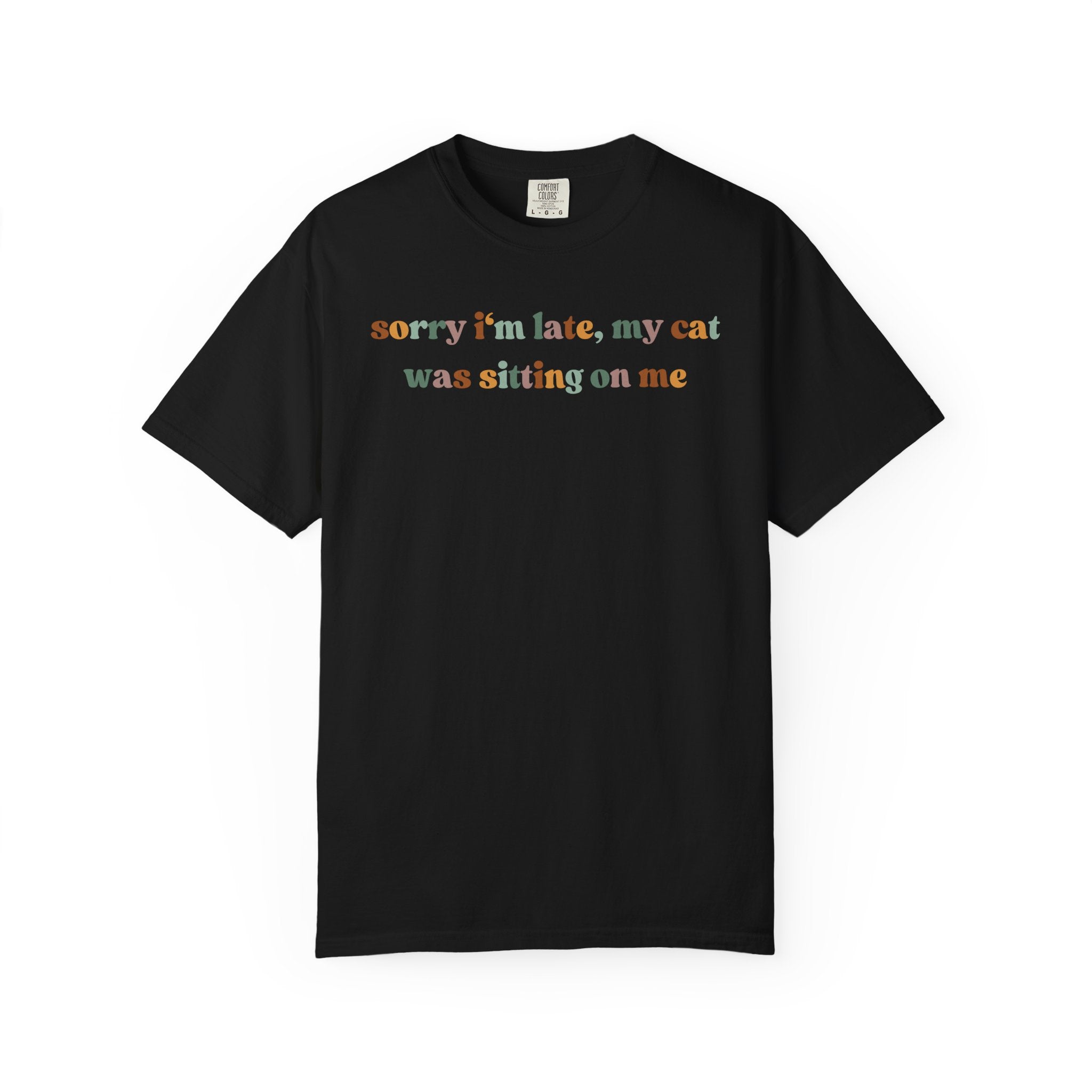 Funny cat lover graphic t-shirt featuring the colorful quote "Sorry I'm Late, My Cat Was Sitting on Me." A humorous gift for cat moms, cat dads, and pet owners.