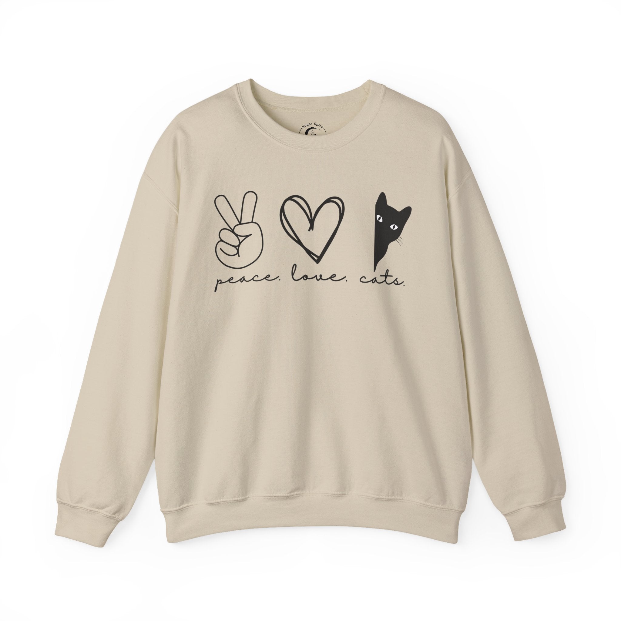 Woman wearing a sand Peace Love Cats sweatshirt featuring a minimalist black cat graphic with a peace sign and heart design.