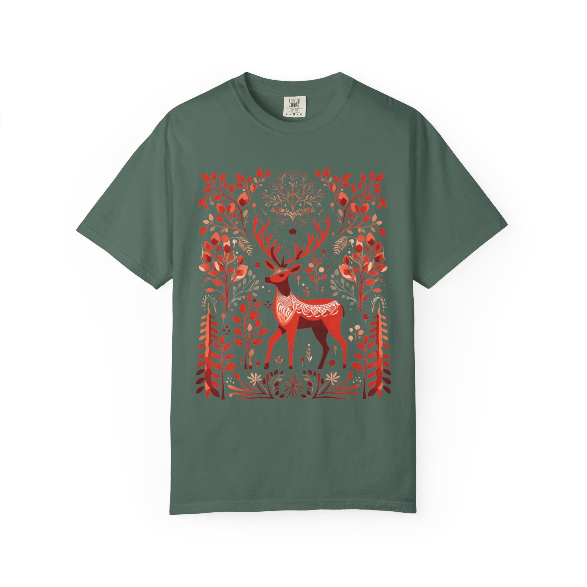 Nordic folk art illustration of a red deer surrounded by stylised branches, leaves, and forest motifs in a Scandinavian-inspired design, printed on a Comfort Colors shirt.
