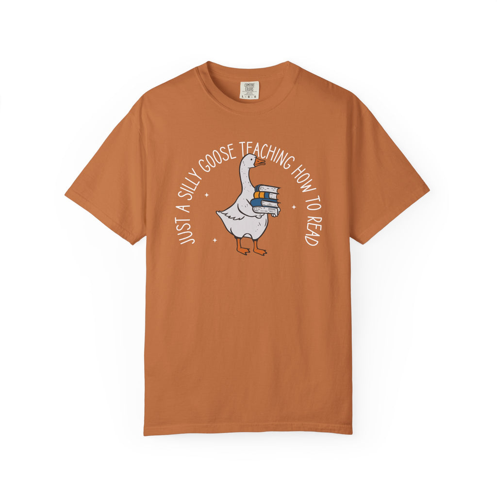 Just a Silly Goose Teaching How to Read text design featuring a cartoon goose holding a stack of books on a black background, created for English teachers.