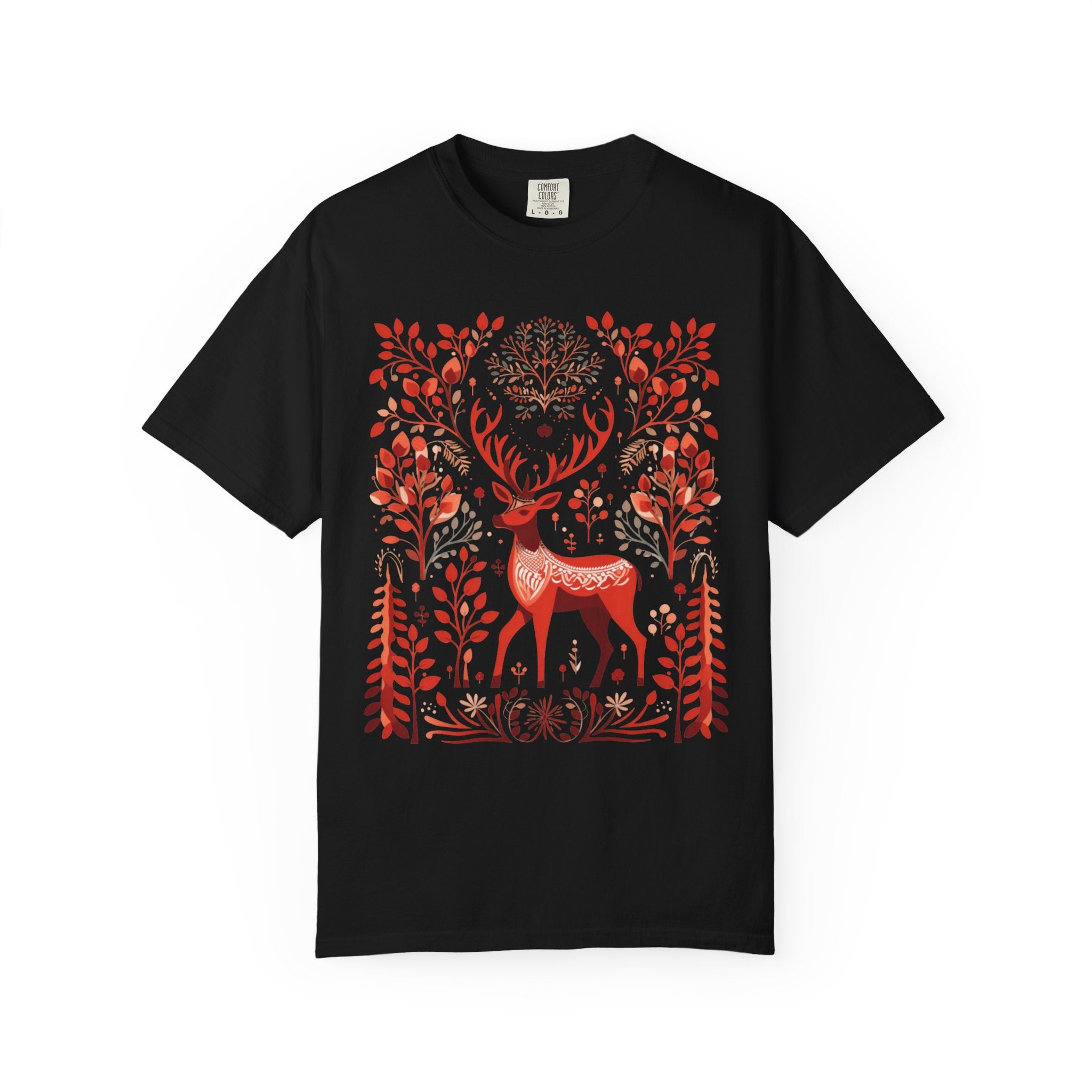 Nordic folk art illustration of a red deer surrounded by stylised branches, leaves, and forest motifs in a Scandinavian-inspired design, printed on a Comfort Colors shirt.