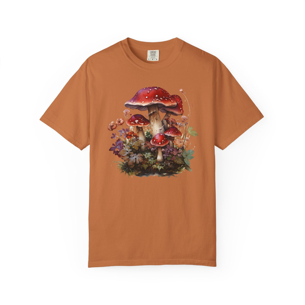 A rust-orange short-sleeve crewneck t-shirt featuring a colorful graphic print of red-capped mushrooms and green foliage on the front, displayed against a solid white background.