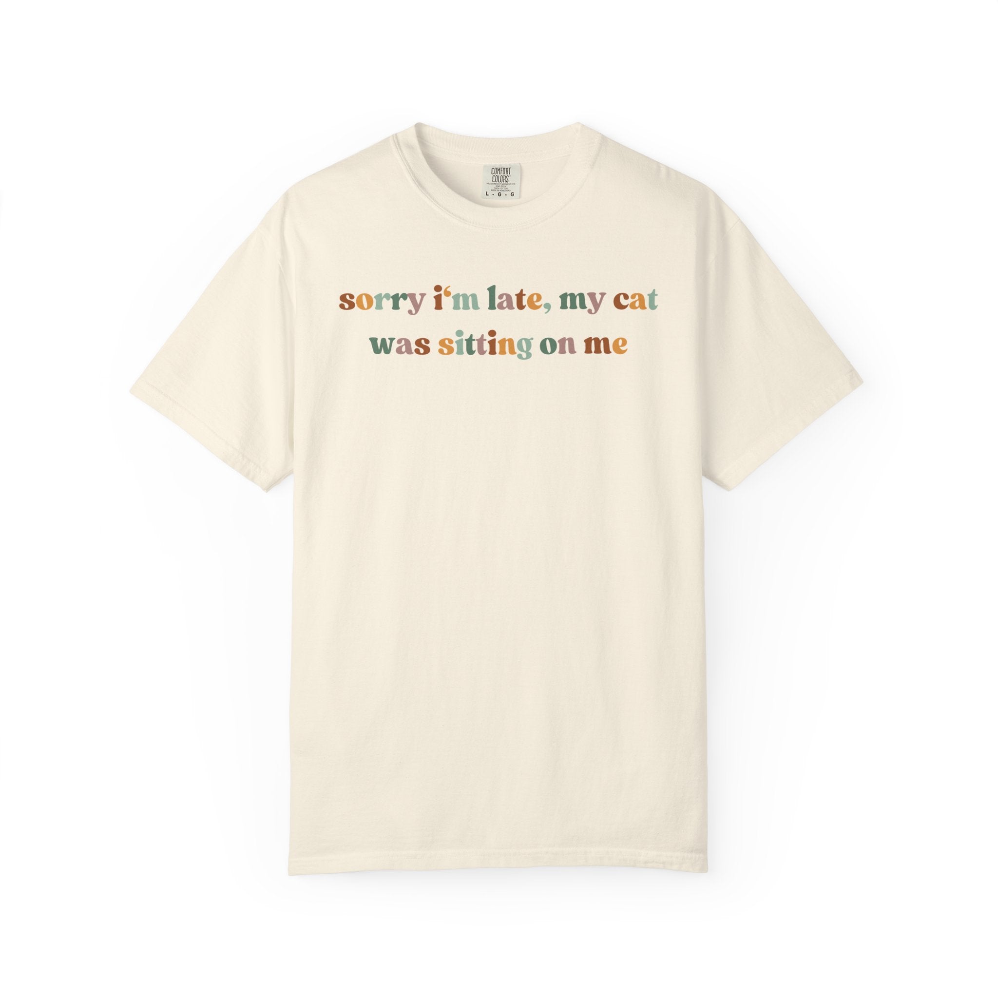 Funny cat lover graphic t-shirt featuring the colorful quote "Sorry I'm Late, My Cat Was Sitting on Me." A humorous gift for cat moms, cat dads, and pet owners.