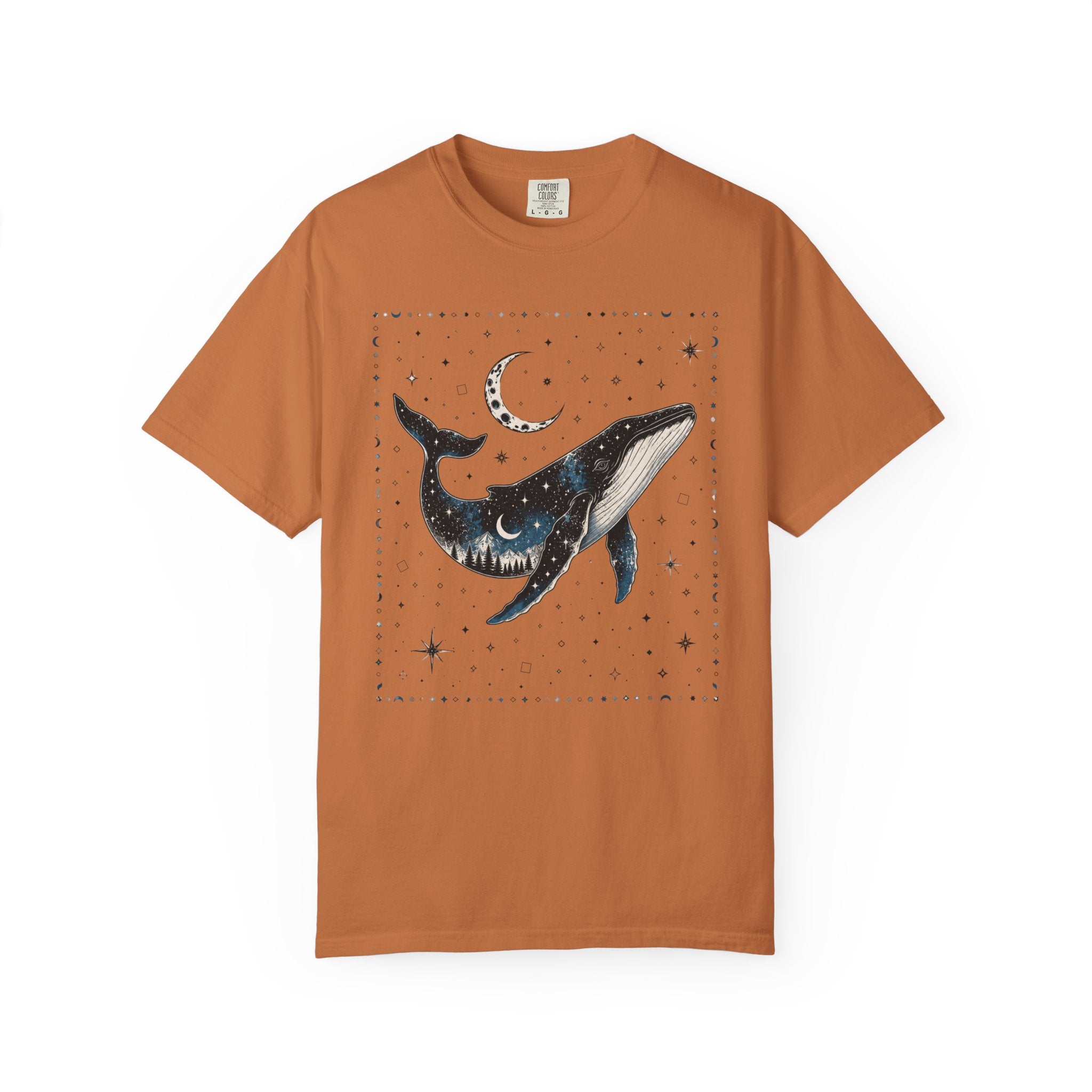 Comfort Colors ivory shirt featuring a celestial whale illustration filled with stars, moonlight, and a forest silhouette beneath a crescent moon.