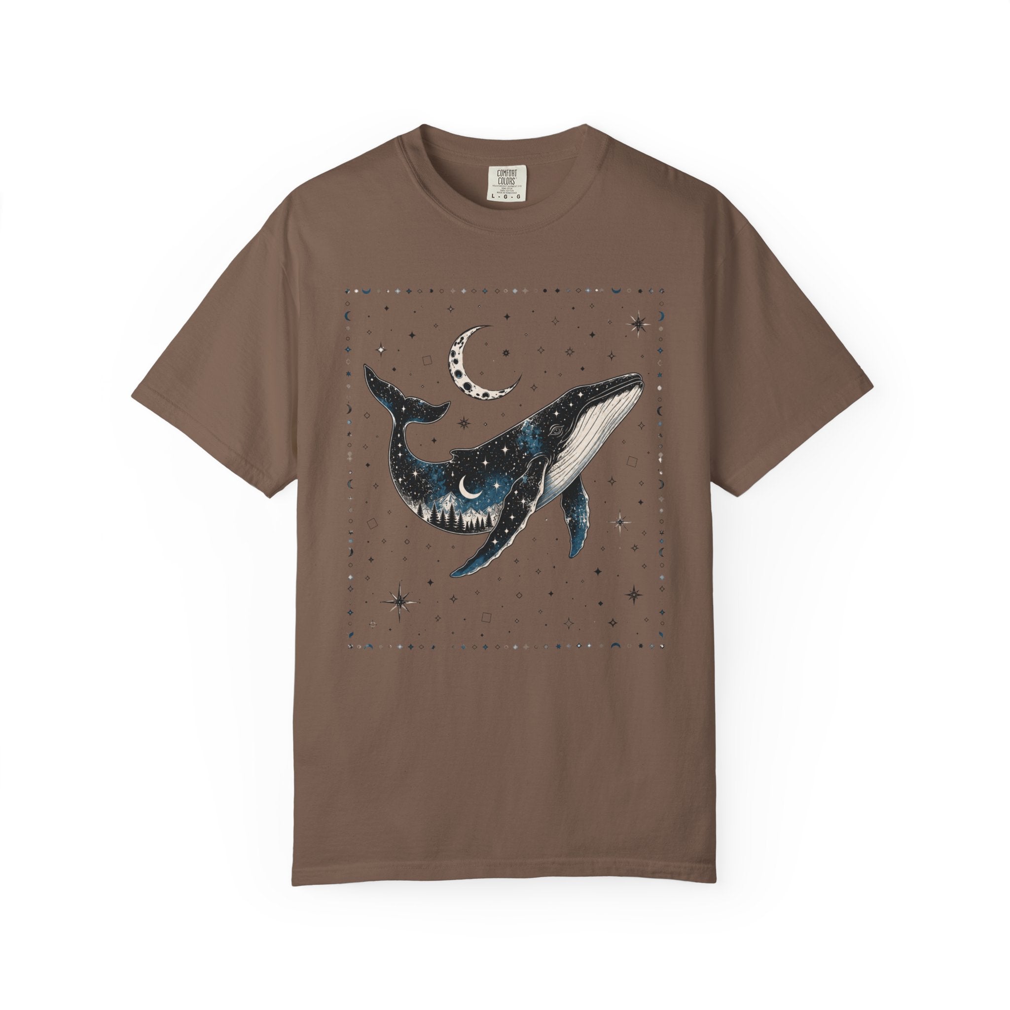 Comfort Colors ivory shirt featuring a celestial whale illustration filled with stars, moonlight, and a forest silhouette beneath a crescent moon.