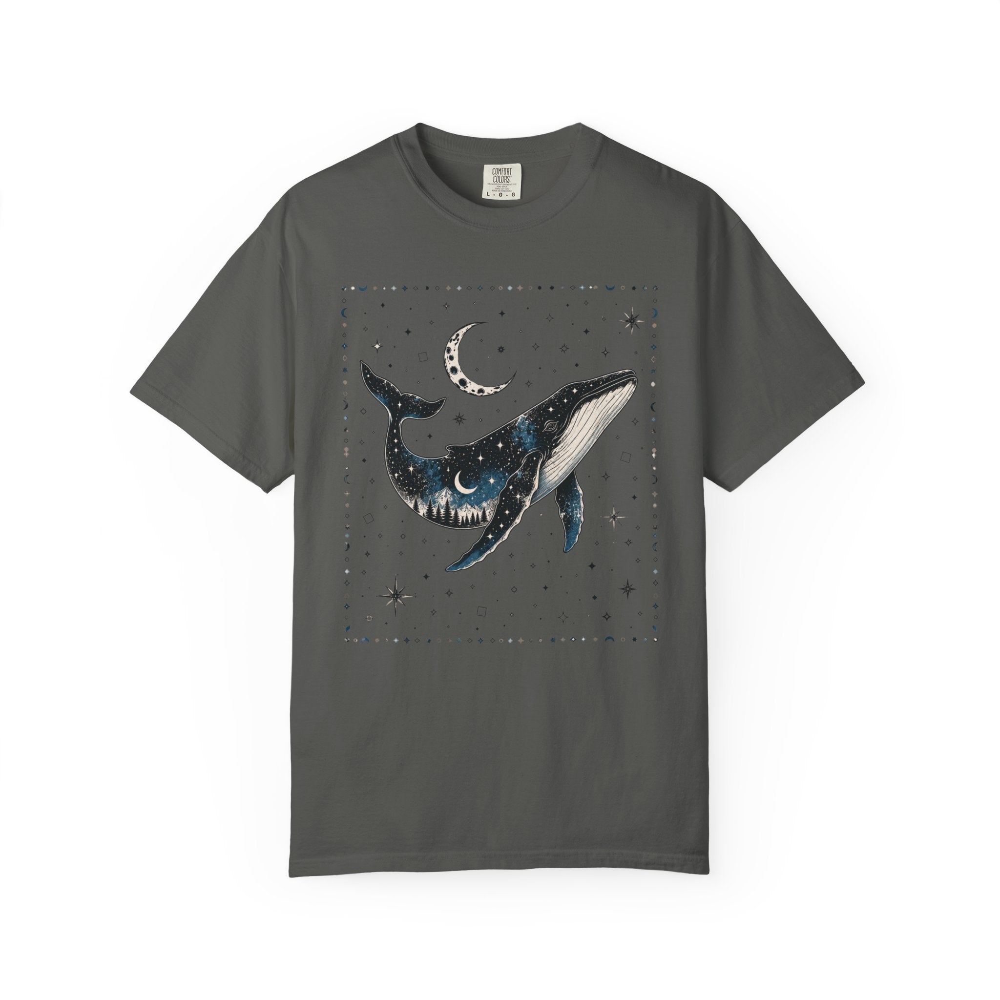 Comfort Colors ivory shirt featuring a celestial whale illustration filled with stars, moonlight, and a forest silhouette beneath a crescent moon.