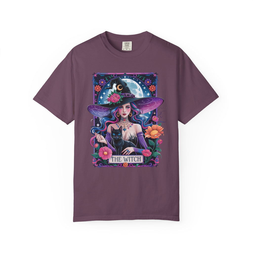 Illustration of a mystical witch with flowing hair, moonlit background, black cat, and floral celestial details on a Halloween shirt.