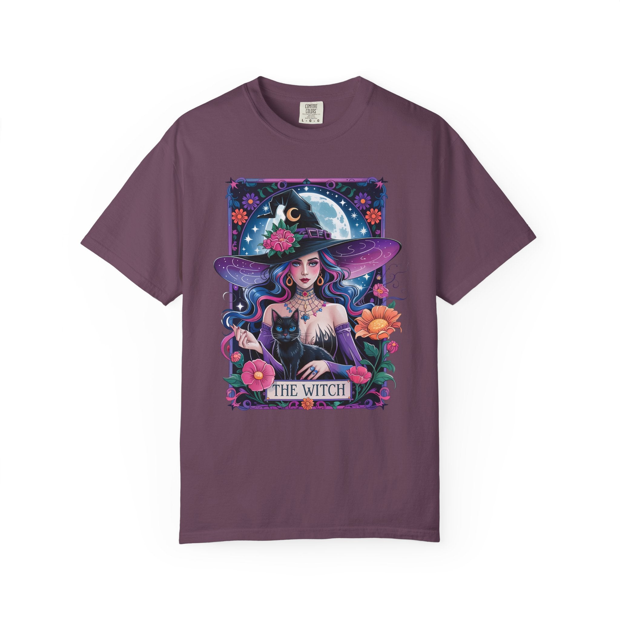 Illustration of a mystical witch with flowing hair, moonlit background, black cat, and floral celestial details on a Halloween shirt.
