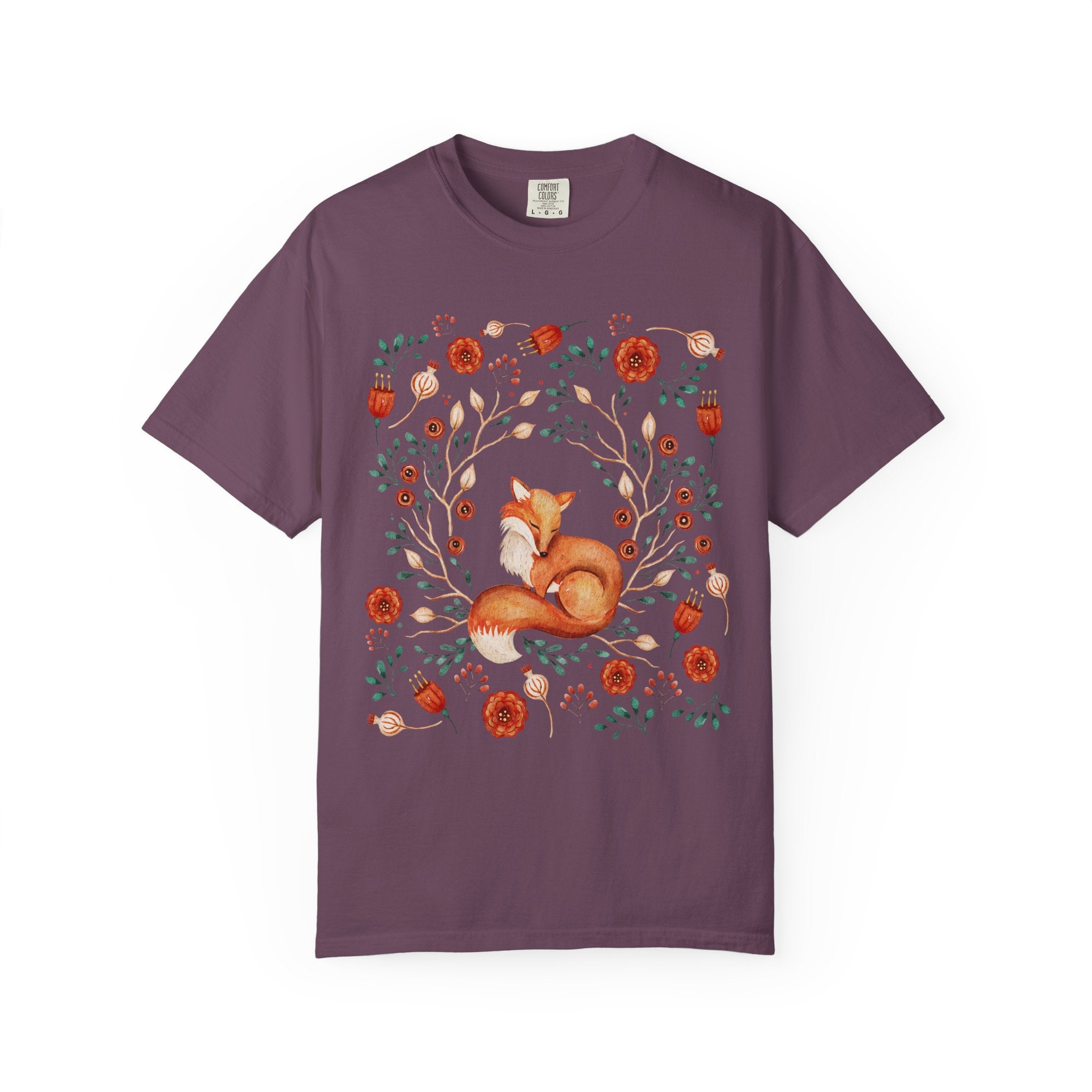Illustration of a sleeping fox surrounded by autumn florals and branches — cozy cottagecore and forestcore aesthetic on a soft Comfort Colors shirt.