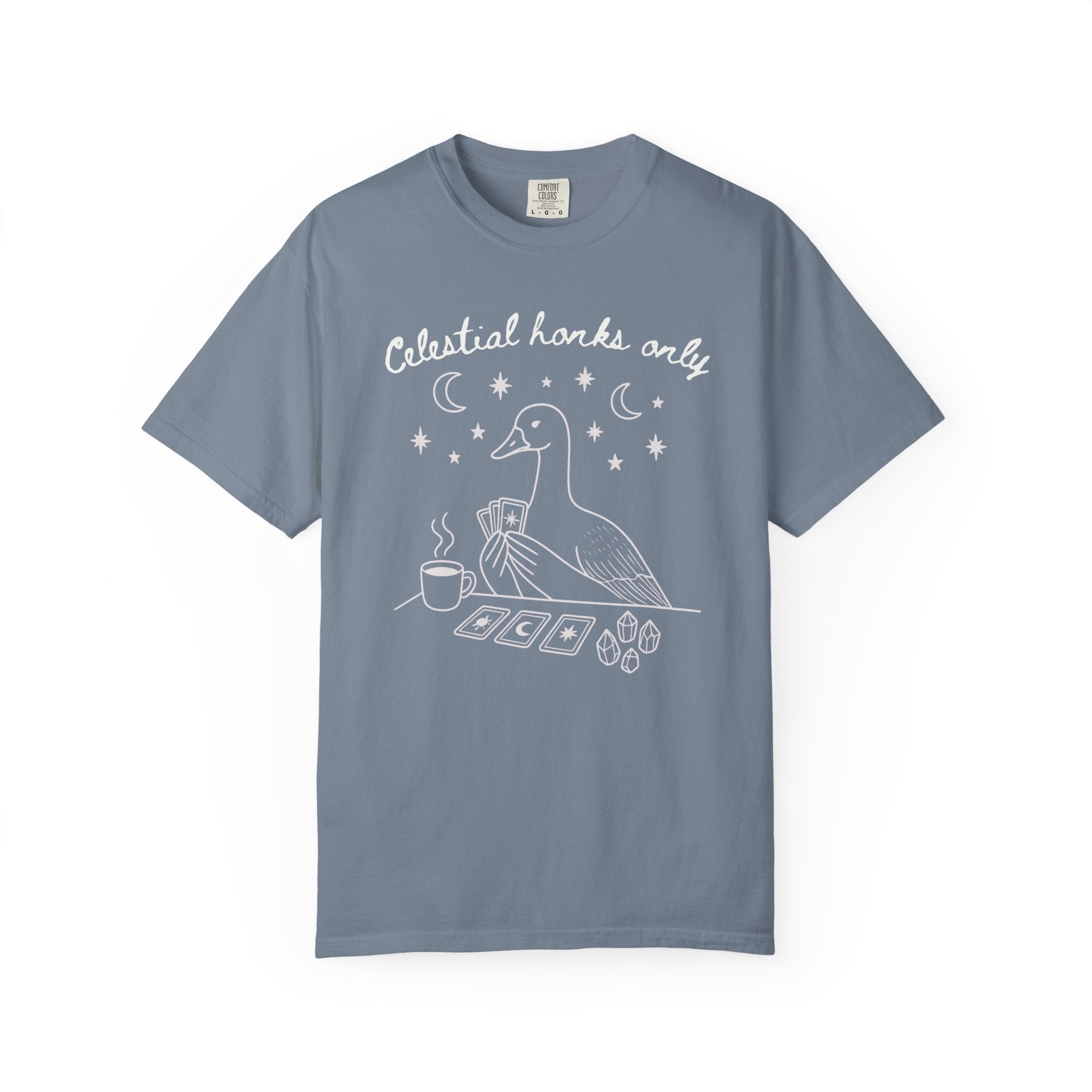 Funny witchy goose graphic featuring a celestial goose holding tarot cards beside a steaming cup of tea, surrounded by stars, crescent moons, and crystals. The design includes the phrase "Celestial Honks Only," making it a whimsical cottagecore and tarot-inspired shirt for goose lovers, tea drinkers, and mystical souls.