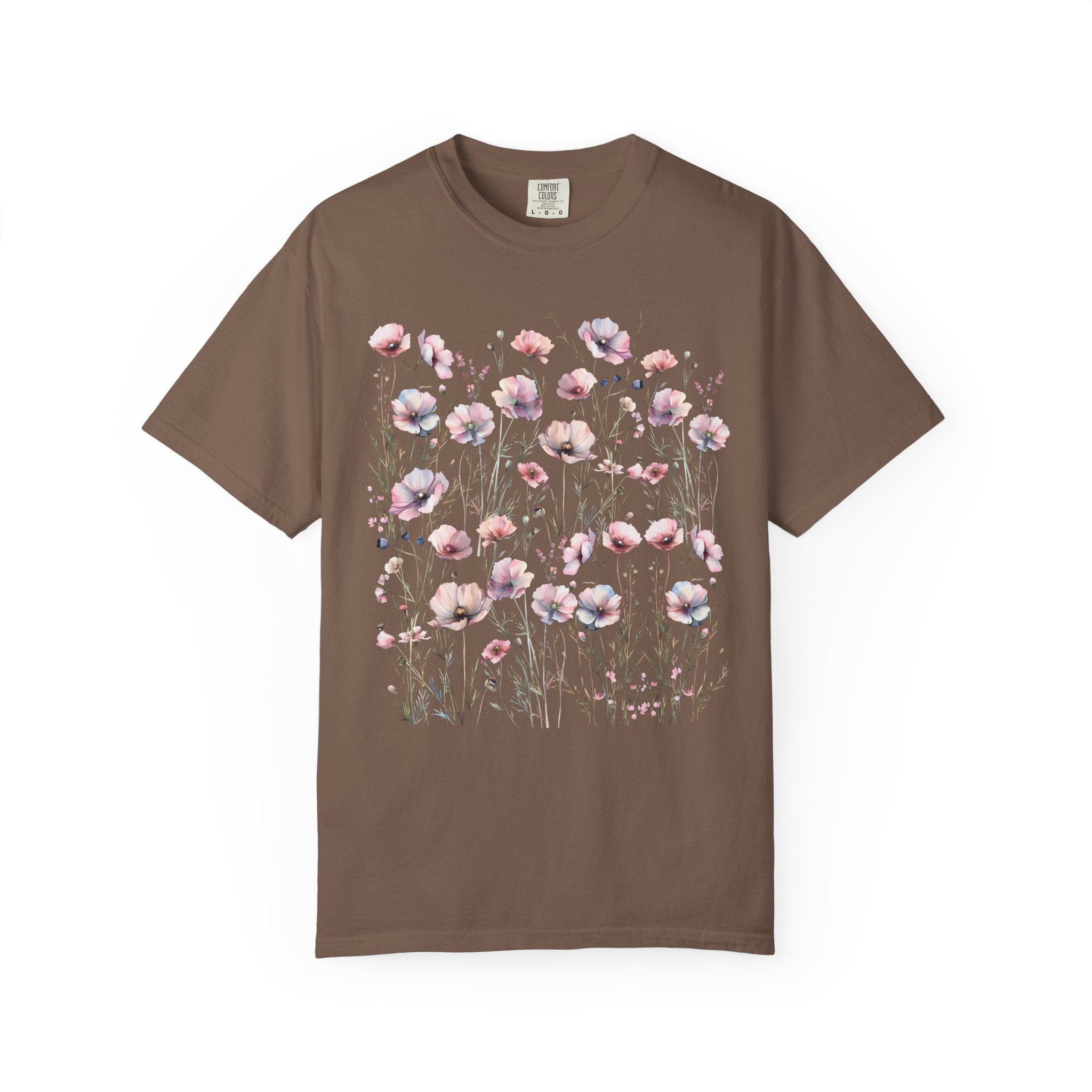 Delicate pastel wildflowers and soft pink blossoms arranged in a meadow pattern on a vintage Comfort Colors cottagecore shirt.