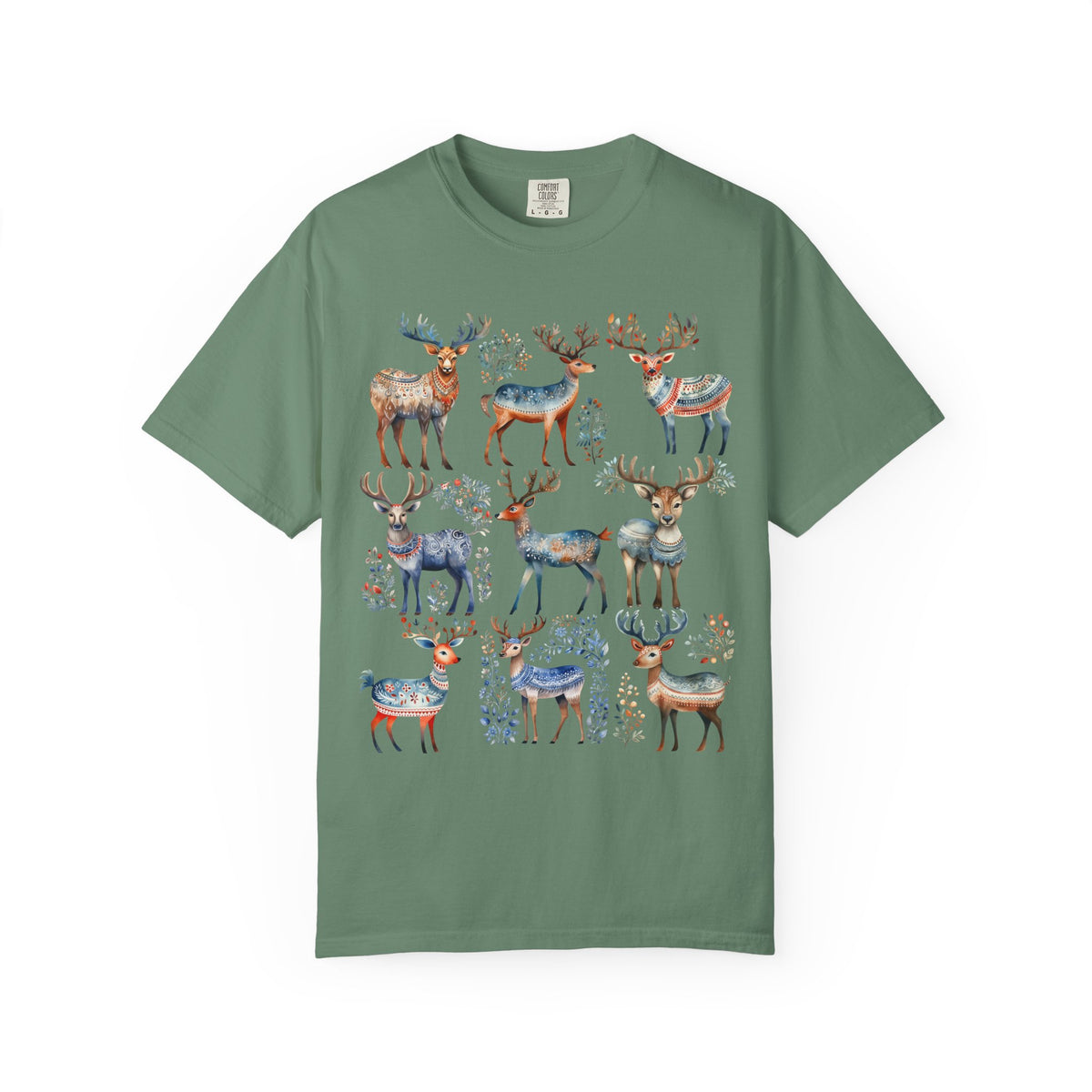 A sage green short-sleeve t-shirt featuring a watercolor-style graphic print of multiple deer in blue, brown, and orange tones with floral details, displayed against a solid white background.