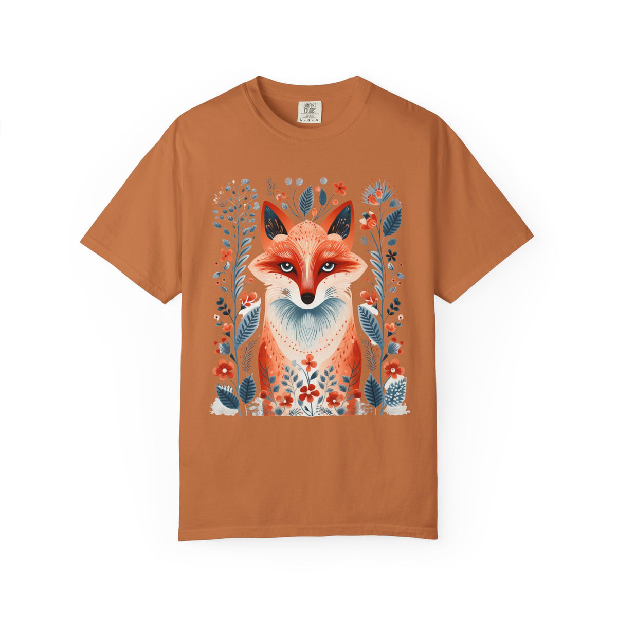 A rust-orange short-sleeve crewneck t-shirt featuring a detailed graphic print of a fox surrounded by blue and red wildflowers on the front, displayed against a solid white background.