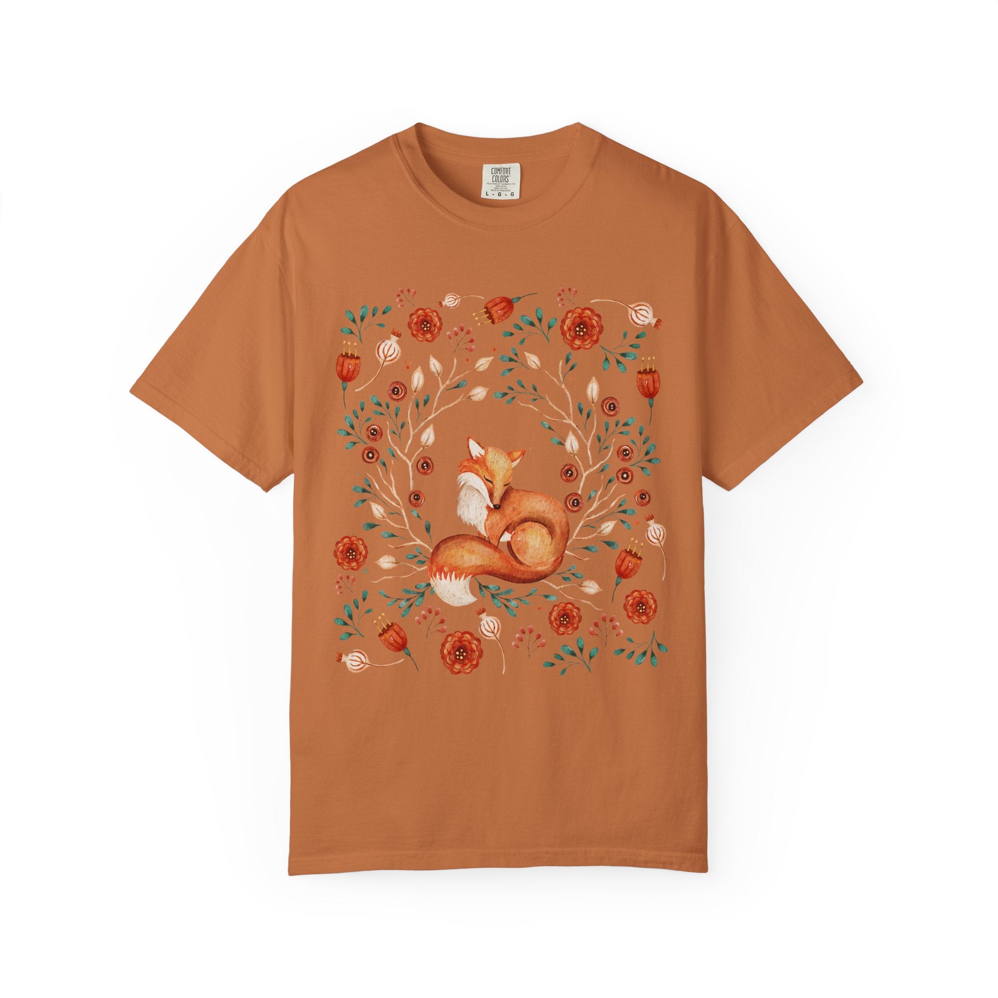 Illustration of a sleeping fox surrounded by autumn florals and branches — cozy cottagecore and forestcore aesthetic on a soft Comfort Colors shirt.