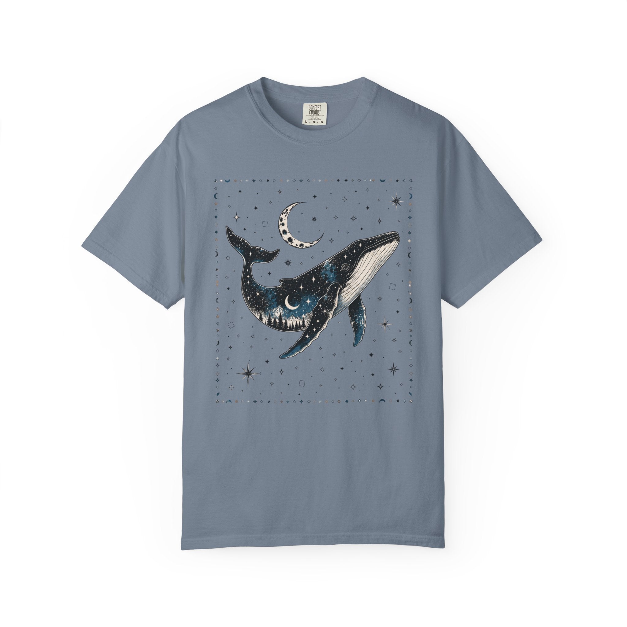 Comfort Colors ivory shirt featuring a celestial whale illustration filled with stars, moonlight, and a forest silhouette beneath a crescent moon.