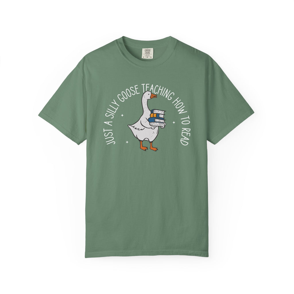 Just a Silly Goose Teaching How to Read text design featuring a cartoon goose holding a stack of books on a black background, created for English teachers.