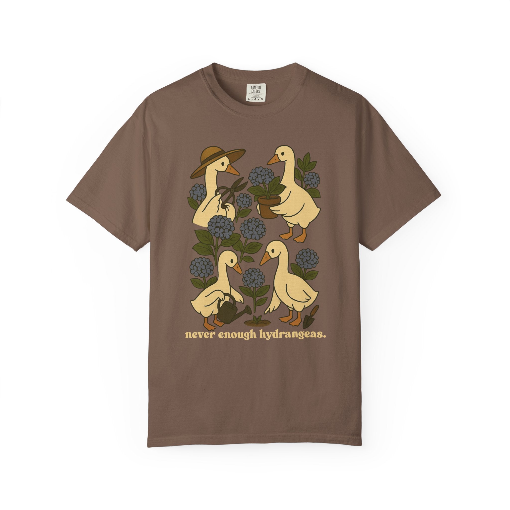 Illustration of four geese gardening among blue hydrangeas with text “never enough hydrangeas.” Cottagecore garden shirt design.