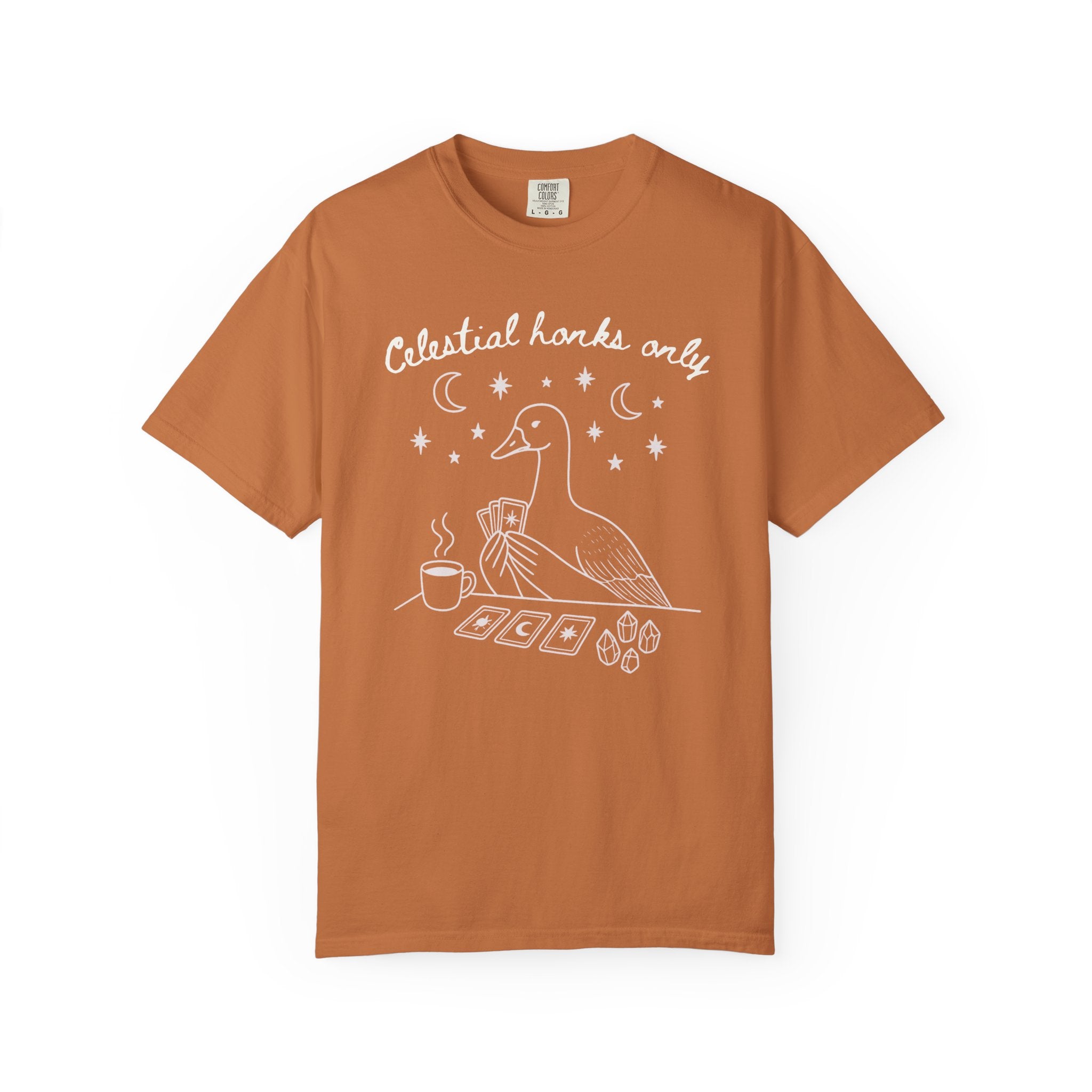 Funny witchy goose graphic featuring a celestial goose holding tarot cards beside a steaming cup of tea, surrounded by stars, crescent moons, and crystals. The design includes the phrase "Celestial Honks Only," making it a whimsical cottagecore and tarot-inspired shirt for goose lovers, tea drinkers, and mystical souls.