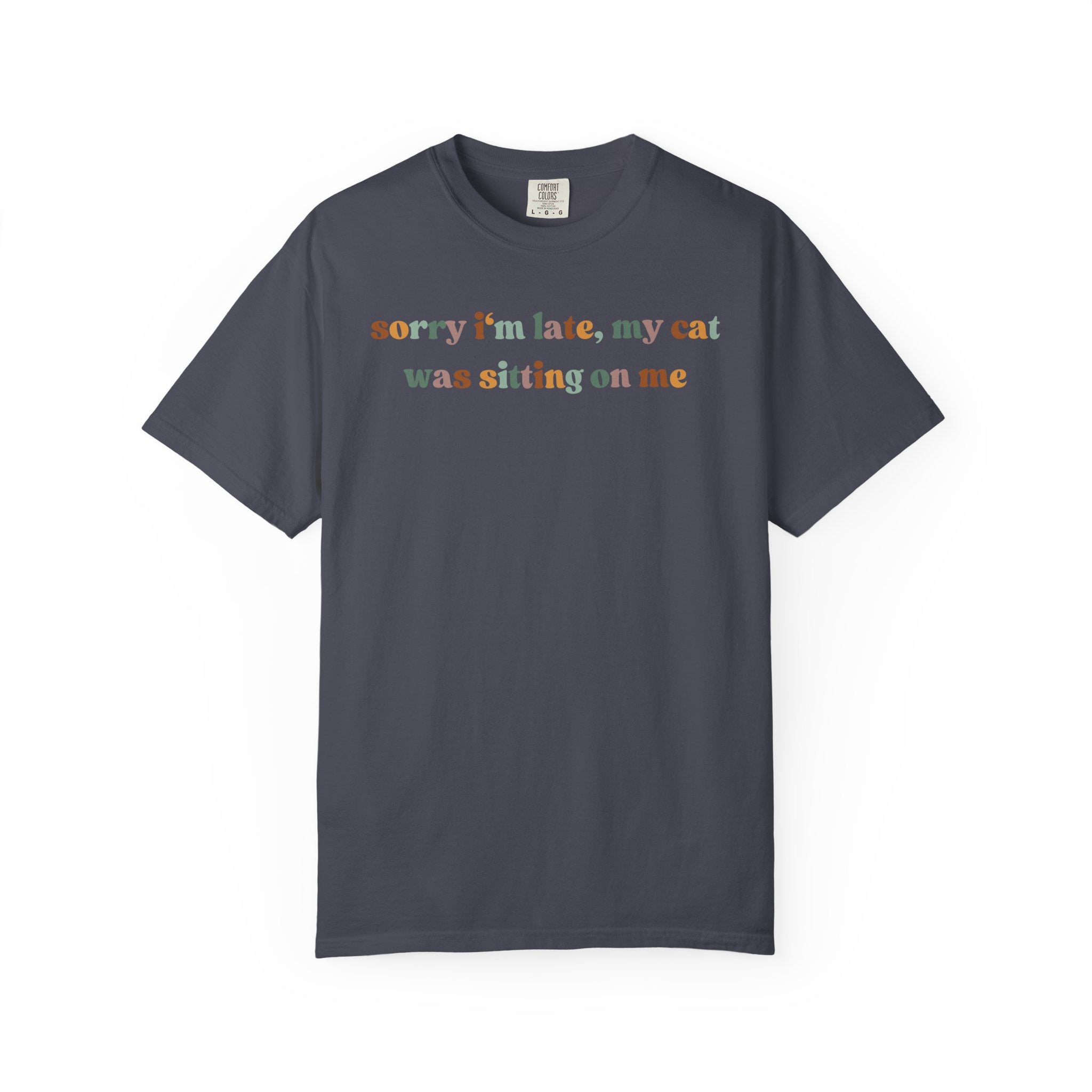 Funny cat lover graphic t-shirt featuring the colorful quote "Sorry I'm Late, My Cat Was Sitting on Me." A humorous gift for cat moms, cat dads, and pet owners.
