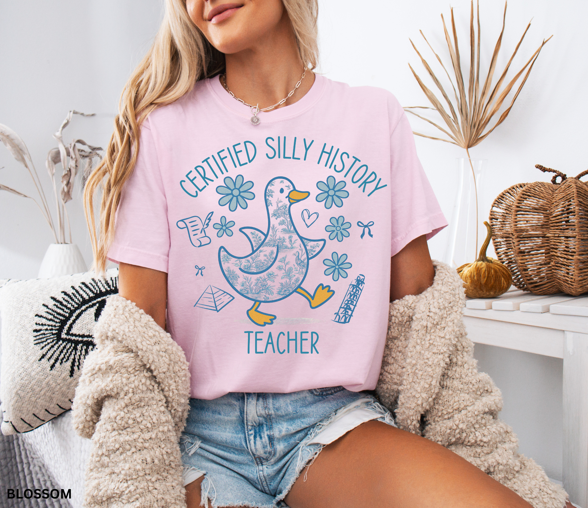 Funny history teacher shirt with a patterned goose surrounded by flowers, bows, and history doodles. Reads ‘Certified Silly History Teacher.’ Perfect classroom tee