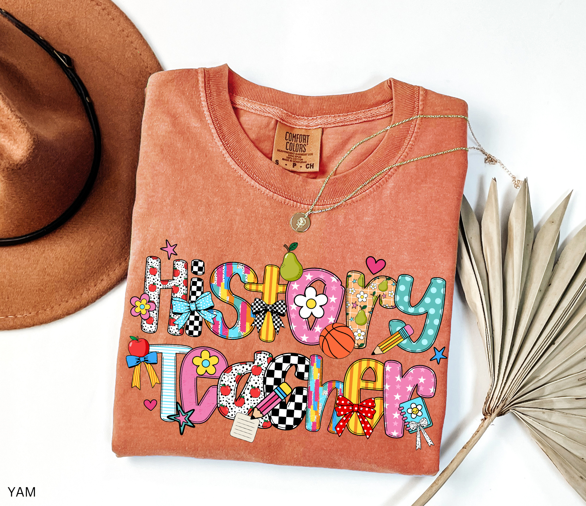 Bright and colorful shirt design with the words “History Teacher” in patchwork-style letters decorated with apples, pencils, bows, flowers, hearts, and stars. Perfect gift for teachers.