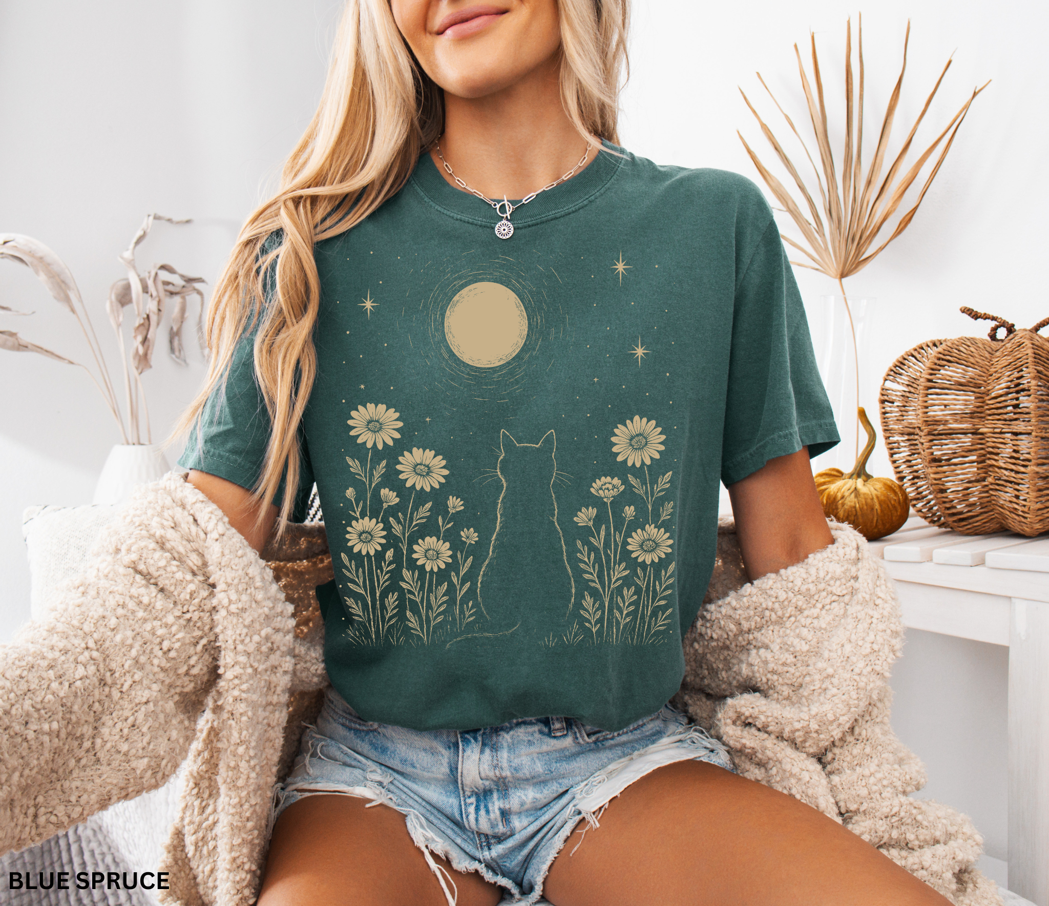 Cottagecore shirt with a black cat sitting in a garden of flowers, gazing at a glowing moon and surrounded by stars in a mystical aesthetic.