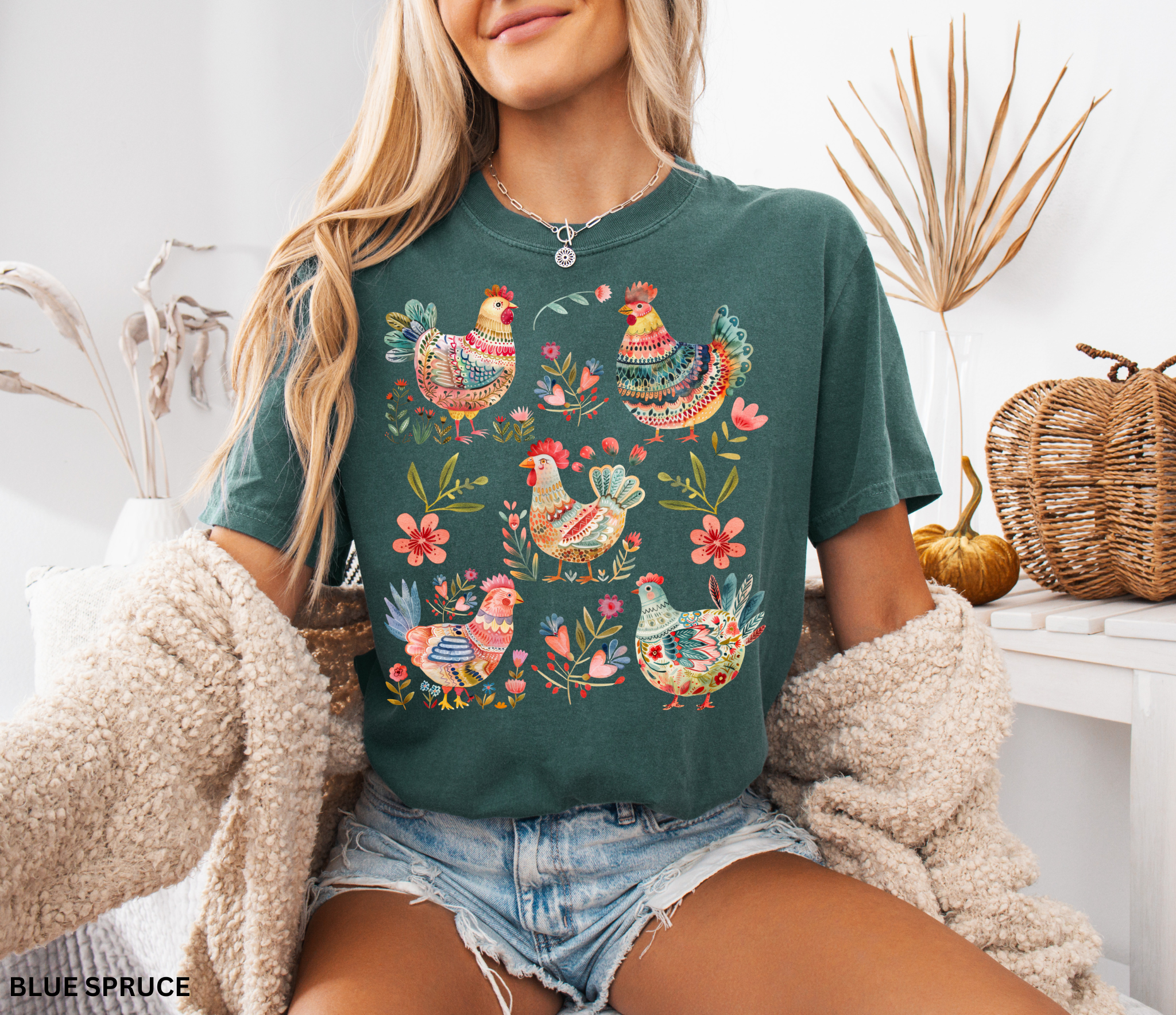 Whimsical folk art style chickens surrounded by colorful flowers, printed as a cottagecore farmhouse design on a t-shirt.
