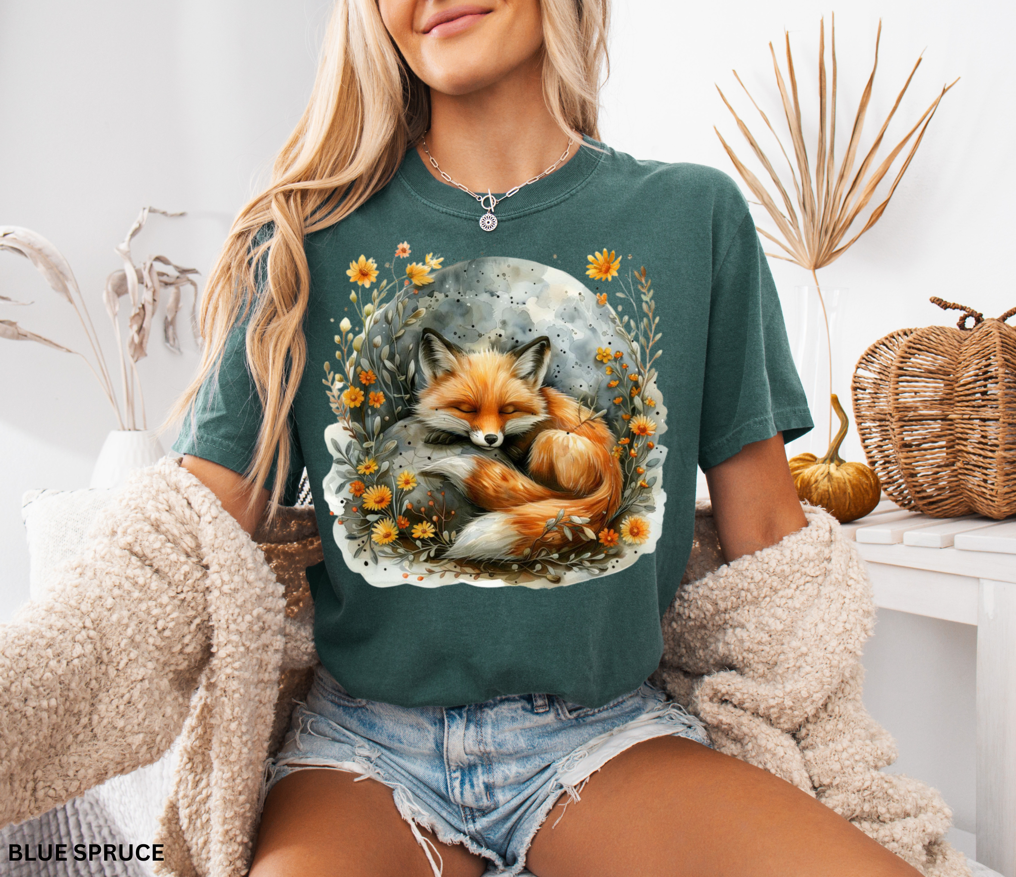 Illustration of a sleeping fox curled beneath a glowing moon, surrounded by golden wildflowers and soft foliage on a cottagecore shirt.