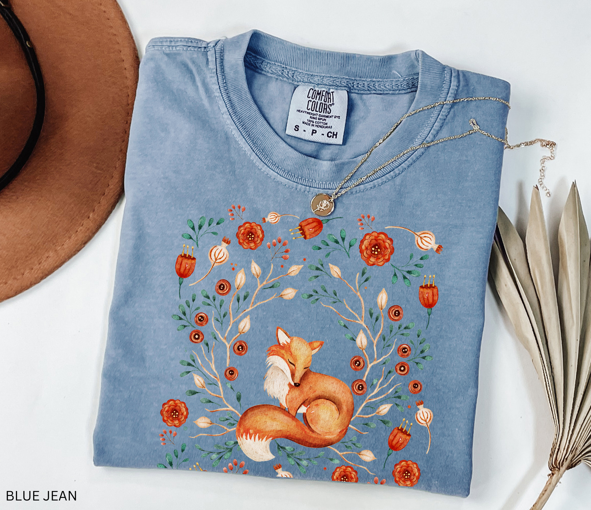 Illustration of a sleeping fox surrounded by autumn florals and branches — cozy cottagecore and forestcore aesthetic on a soft Comfort Colors shirt.