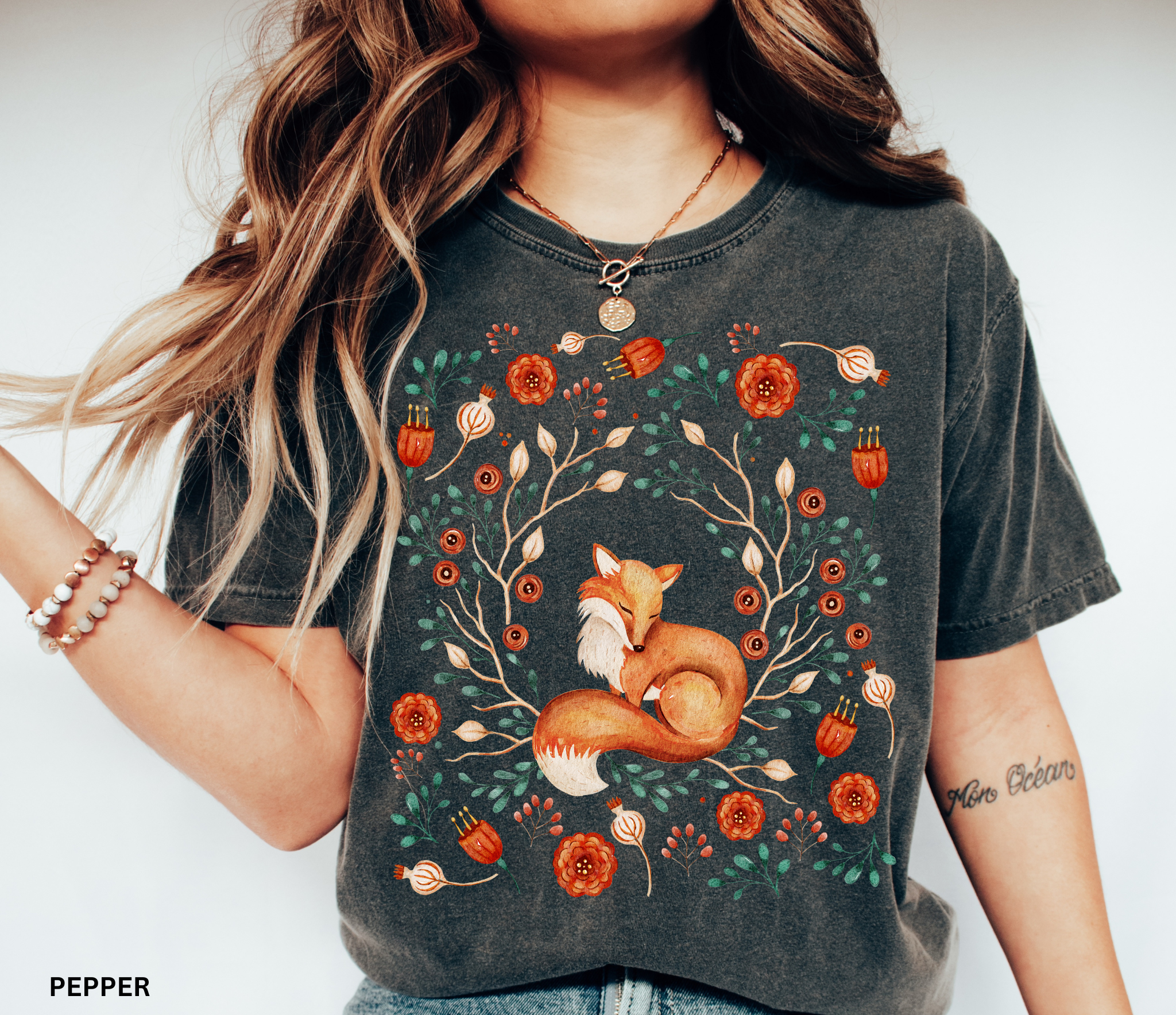 Illustration of a sleeping fox surrounded by autumn florals and branches — cozy cottagecore and forestcore aesthetic on a soft Comfort Colors shirt.