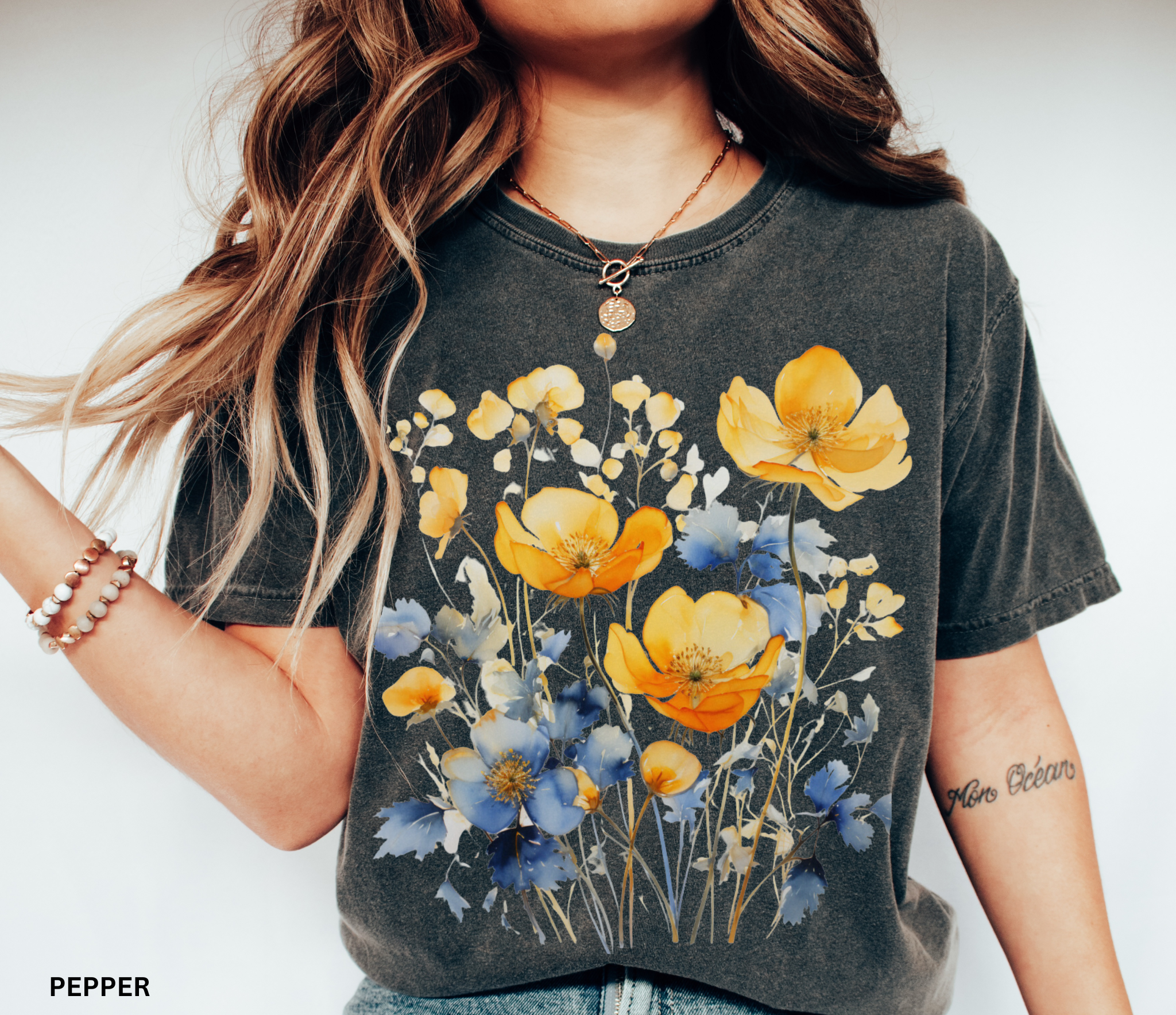 Comfort Colors Pepper t-shirt featuring a Nordic wildflower botanical design with earthy orange, yellow, and charcoal florals in a cottagecore style
