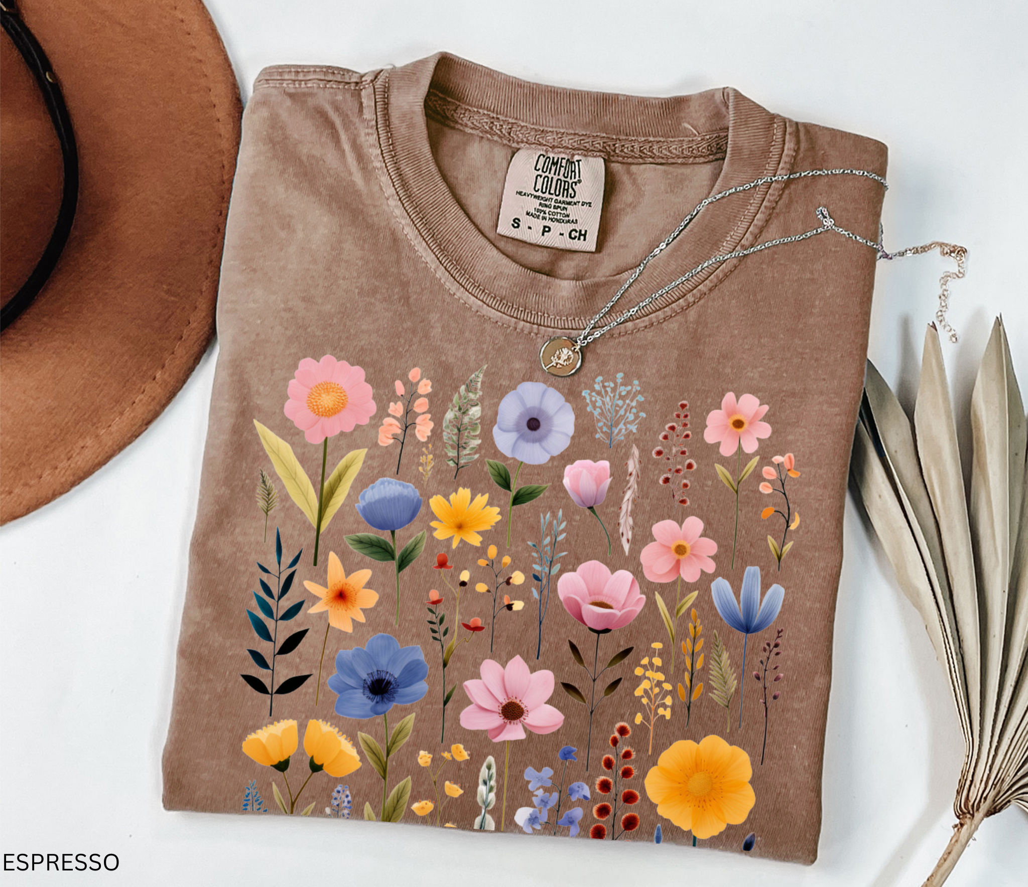 Comfort Colors shirt featuring a pastel Nordic wildflower botanical design with soft pink, blue, and yellow florals in a cottagecore style