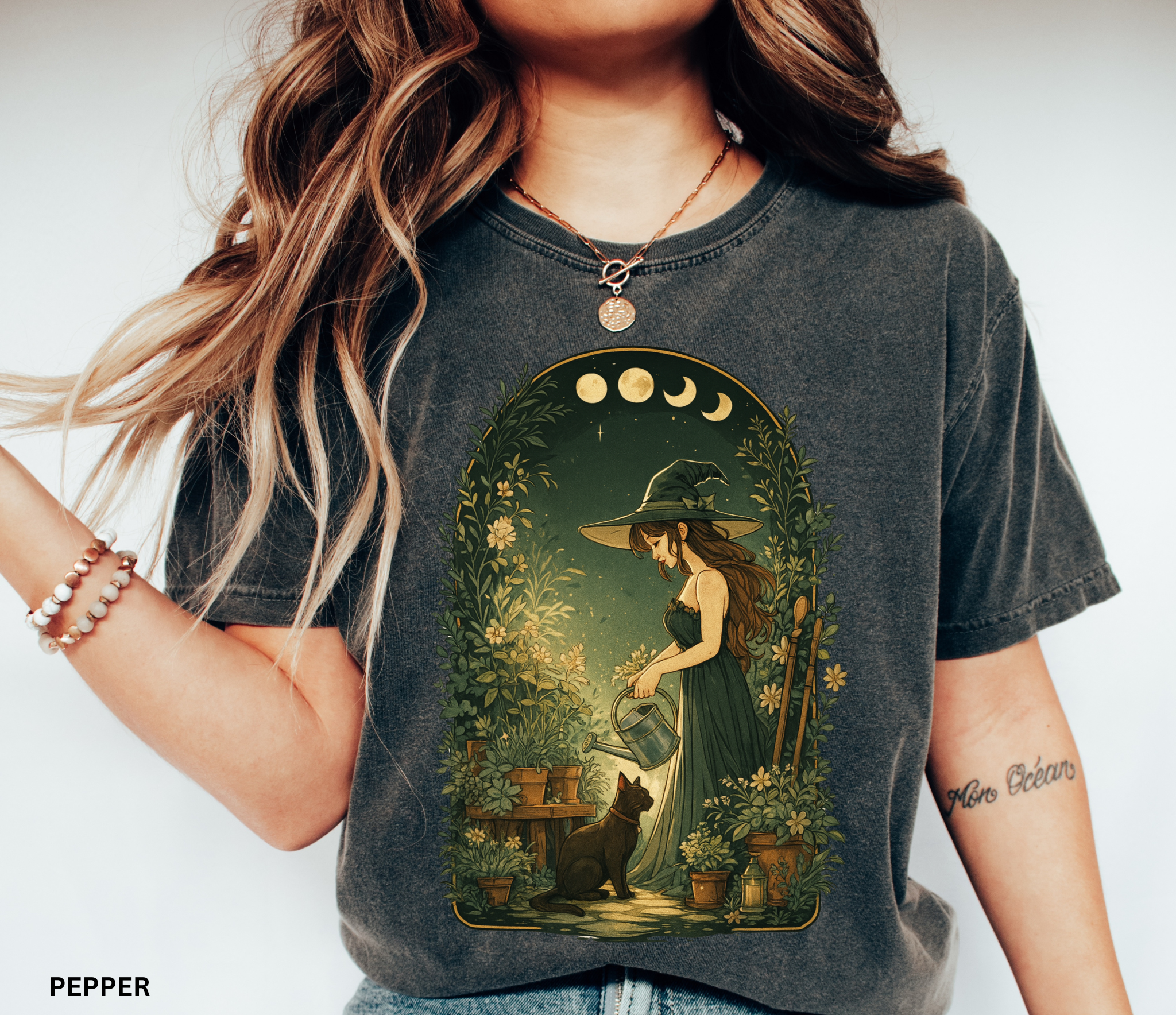Cottagecore illustration of a garden witch in a green dress watering plants under moon phases, surrounded by foliage and flowers with a black cat by her side.
