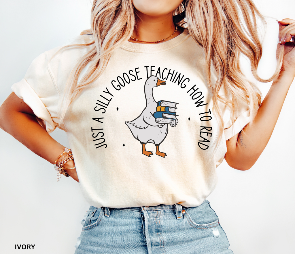 Just a Silly Goose Teaching How to Read text design featuring a cartoon goose holding a stack of books on a black background, created for English teachers.