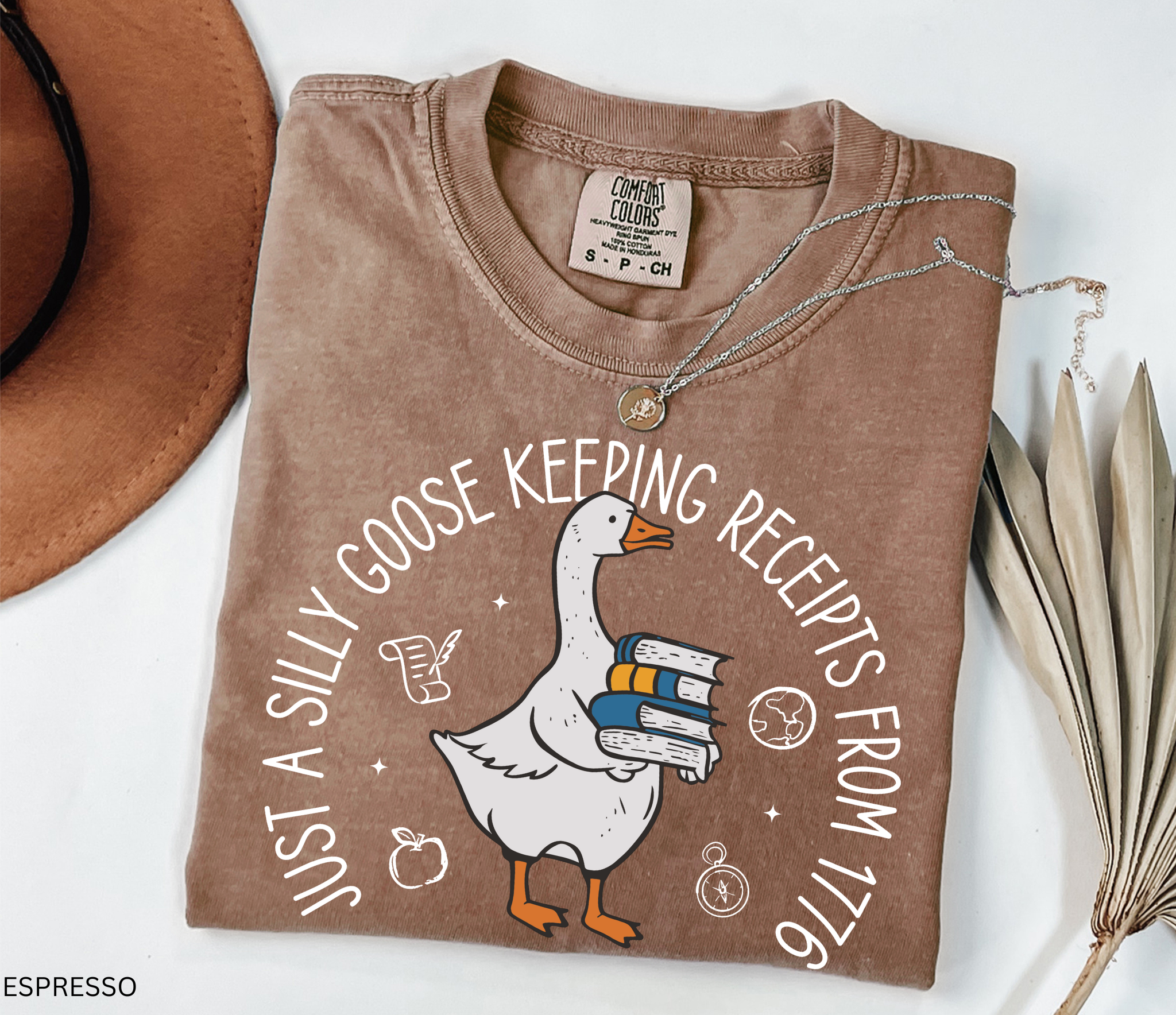 History teacher shirt with a goose holding books and the phrase ‘Just a Historical Goose Keeping Receipts from 1776.’ Funny teacher gift tee