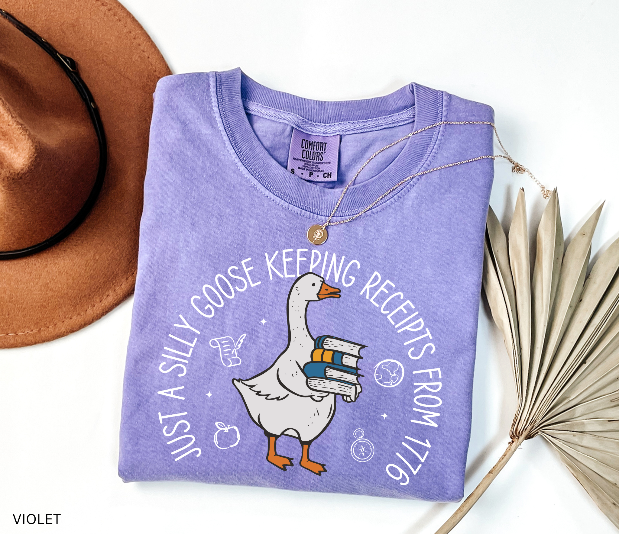History teacher shirt with a goose holding books and the phrase ‘Just a Historical Goose Keeping Receipts from 1776.’ Funny teacher gift tee