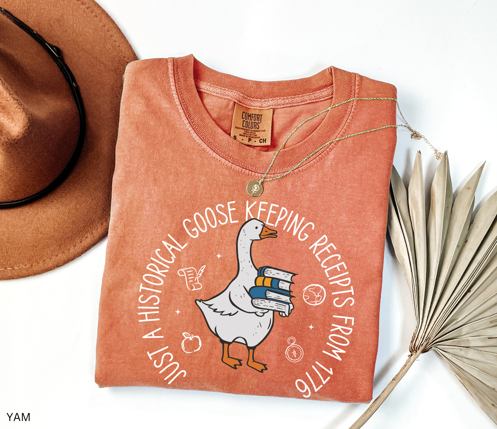 History teacher shirt with a goose holding books and the phrase ‘Just a Historical Goose Keeping Receipts from 1776.’ Funny teacher gift tee.