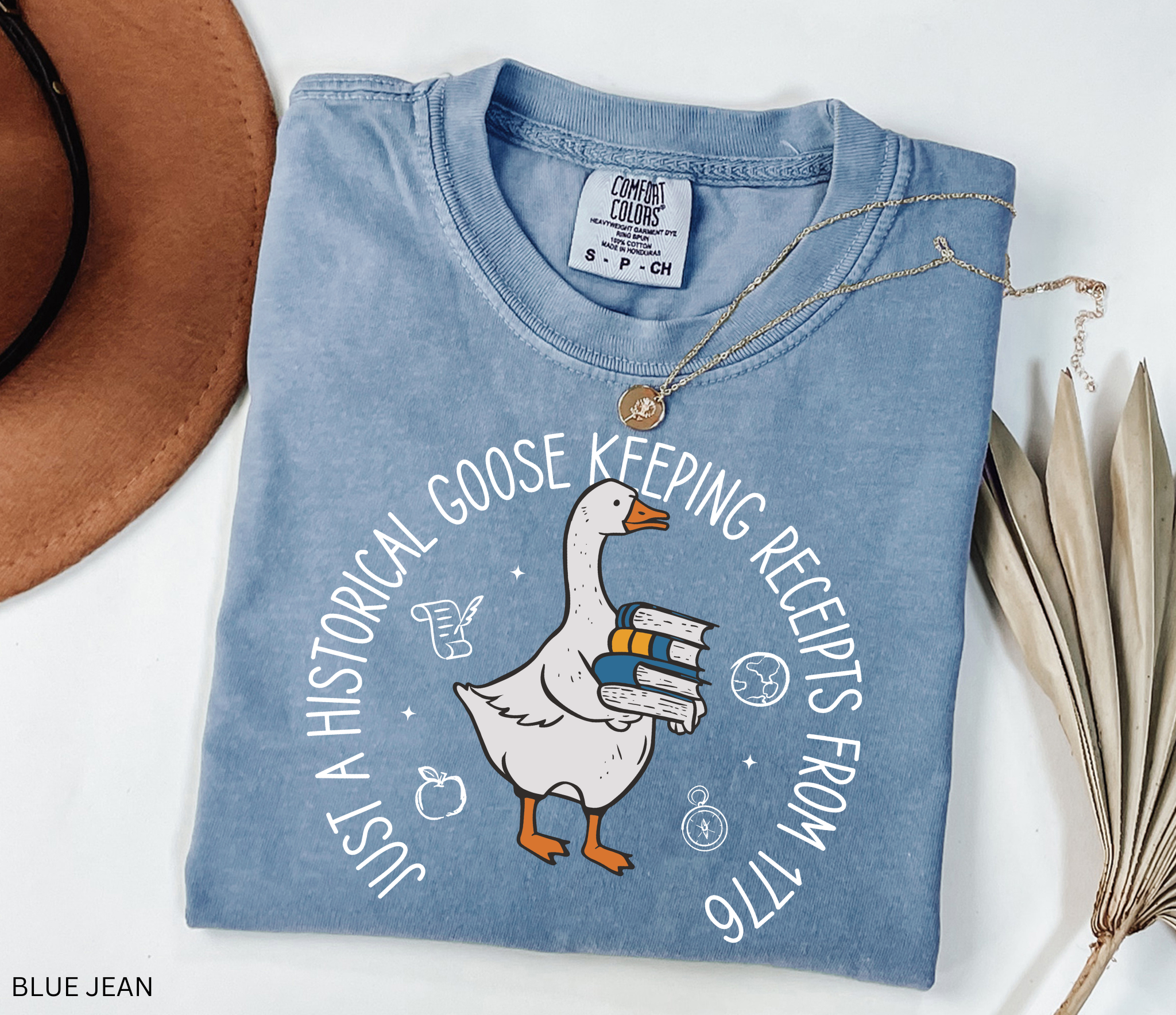 History teacher shirt with a goose holding books and the phrase ‘Just a Historical Goose Keeping Receipts from 1776.’ Funny teacher gift tee.