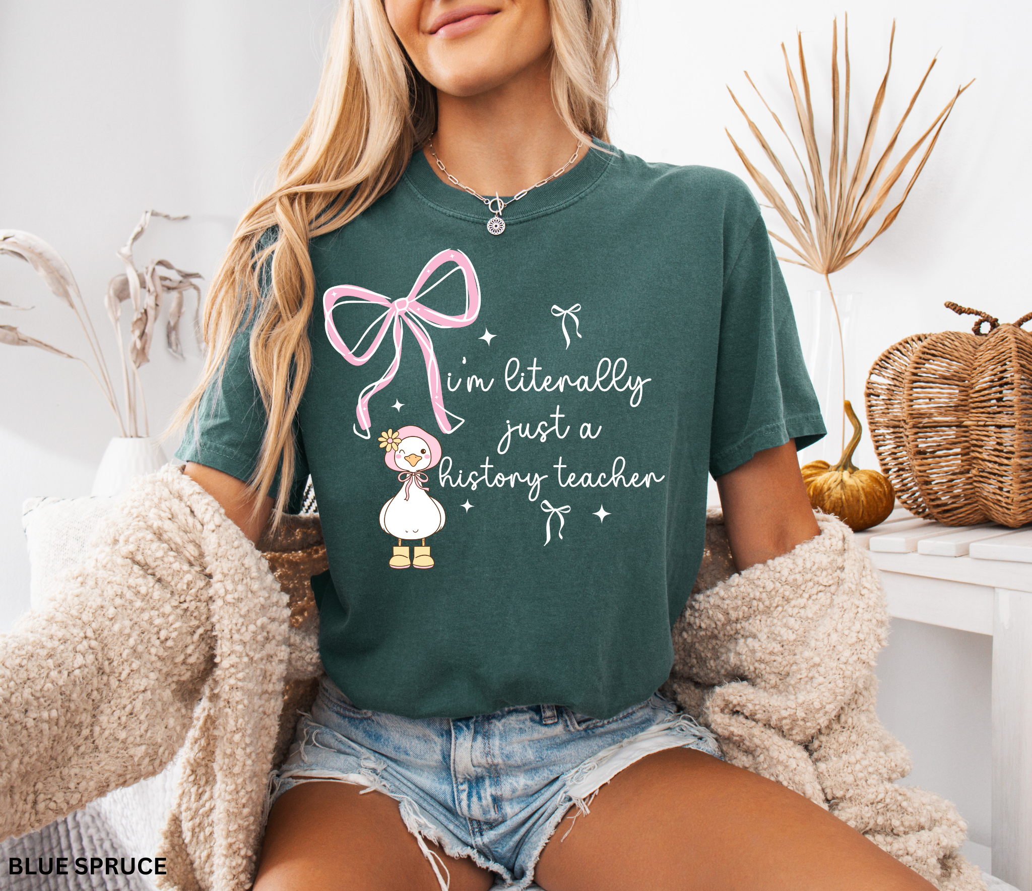 Funny history teacher shirt with a cute goose, pink bows, and the phrase ‘I’m literally just a history teacher.’ Coquette aesthetic social studies tee.