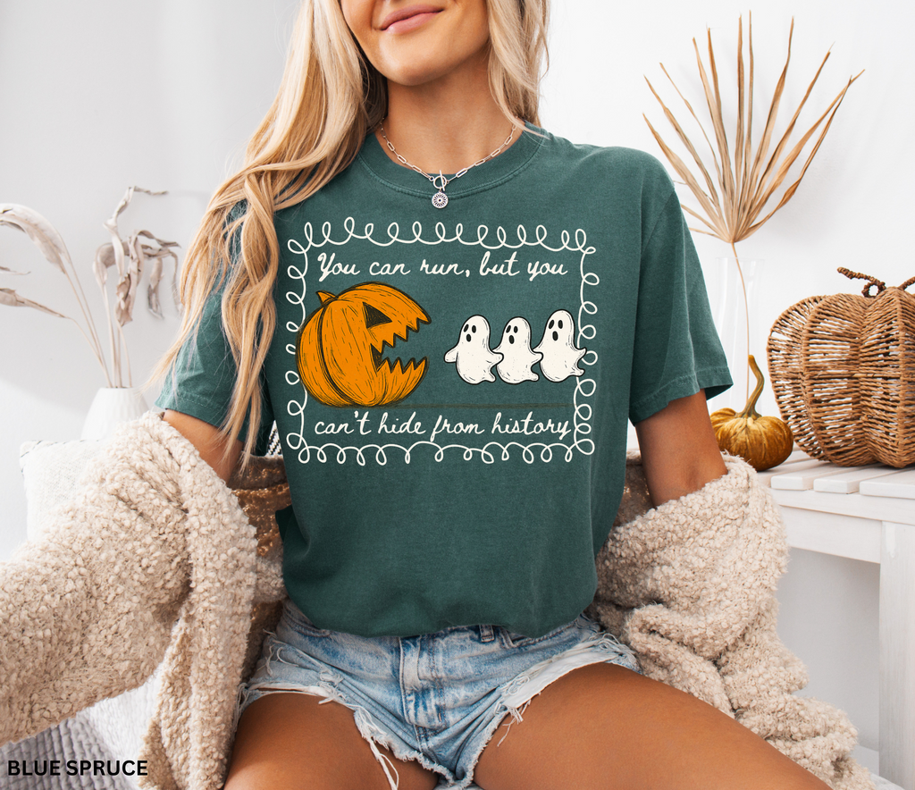 Halloween history teacher shirt with a pumpkin chasing ghosts and the phrase ‘You can run, but you can’t hide from history.’ Funny spooky season teacher tee.