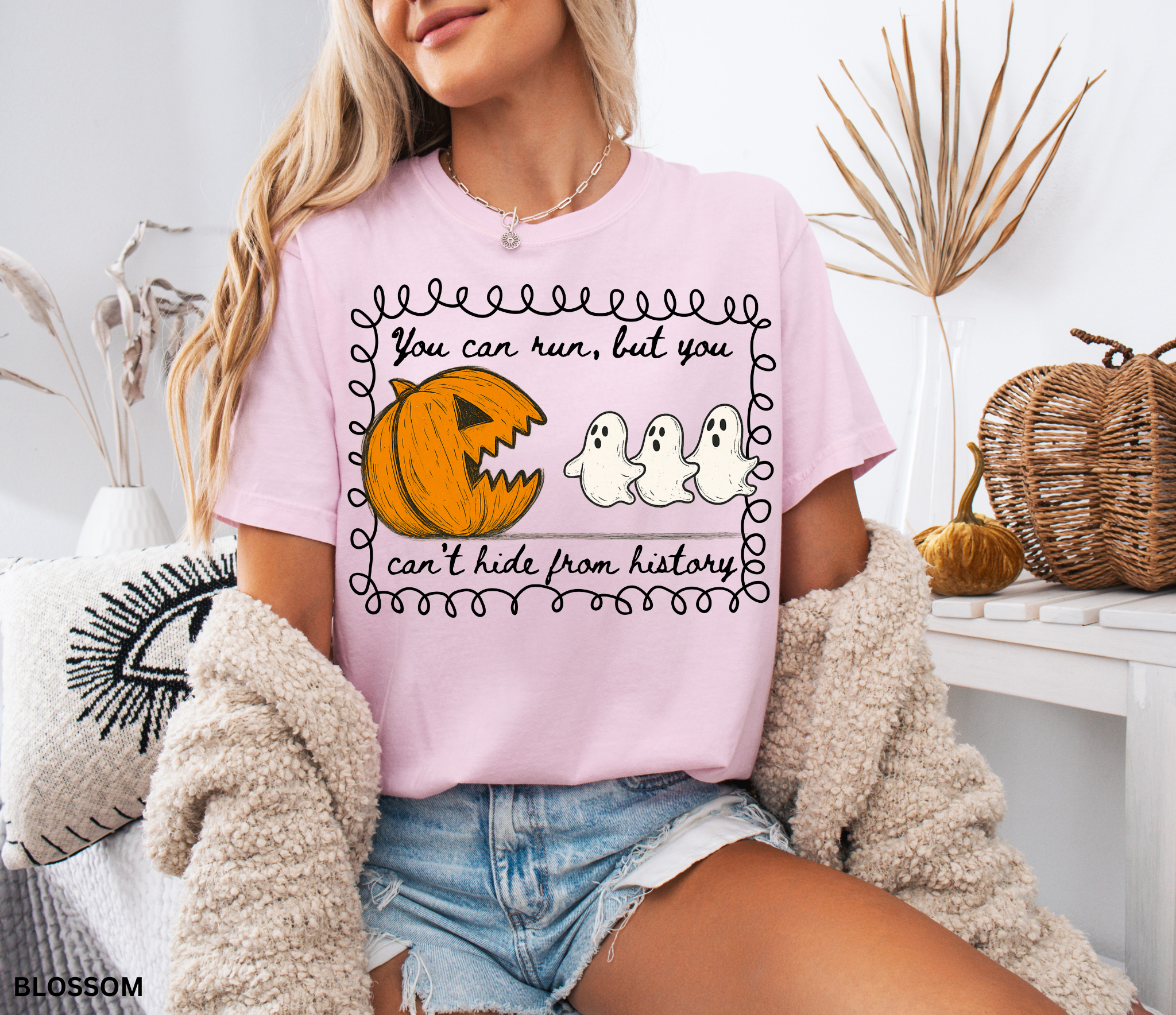 Halloween history teacher shirt with a pumpkin chasing ghosts and the phrase ‘You can run, but you can’t hide from history.’ Funny spooky season teacher tee.