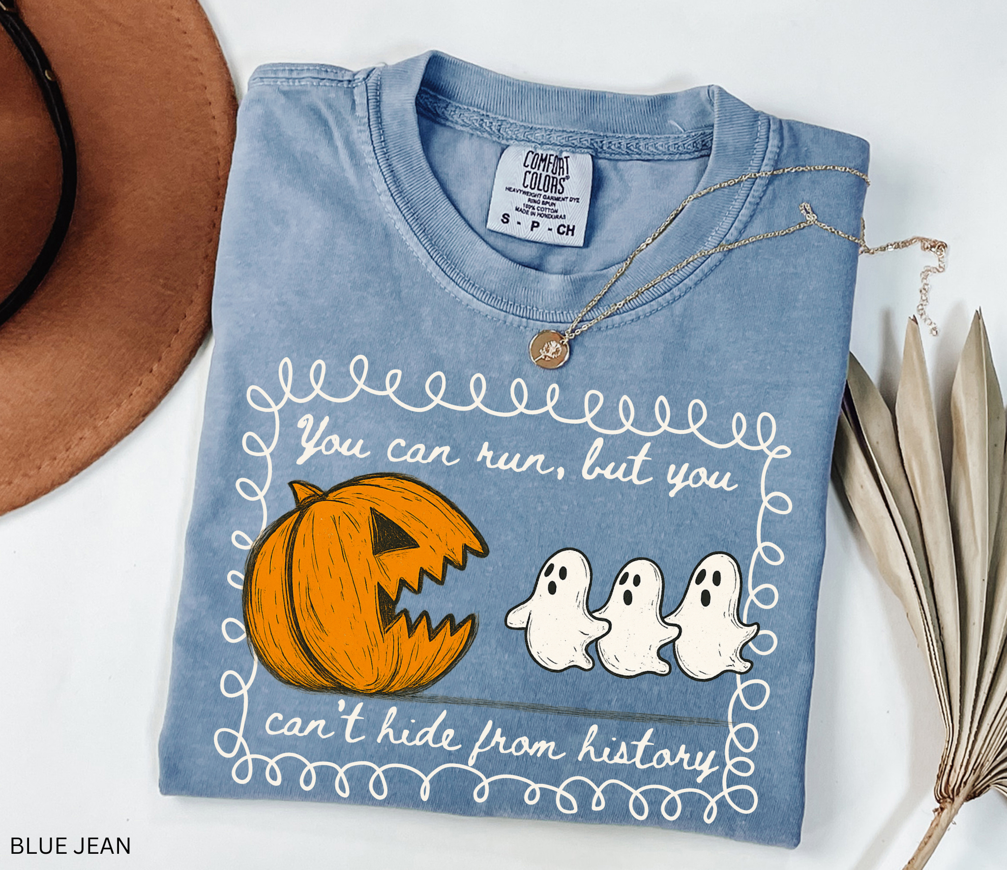 Halloween history teacher shirt with a pumpkin chasing ghosts and the phrase ‘You can run, but you can’t hide from history.’ Funny spooky season teacher tee.