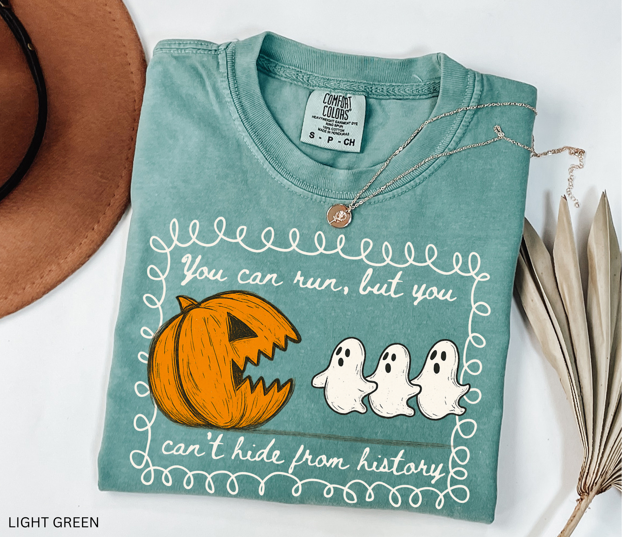 Halloween history teacher shirt with a pumpkin chasing ghosts and the phrase ‘You can run, but you can’t hide from history.’ Funny spooky season teacher tee.