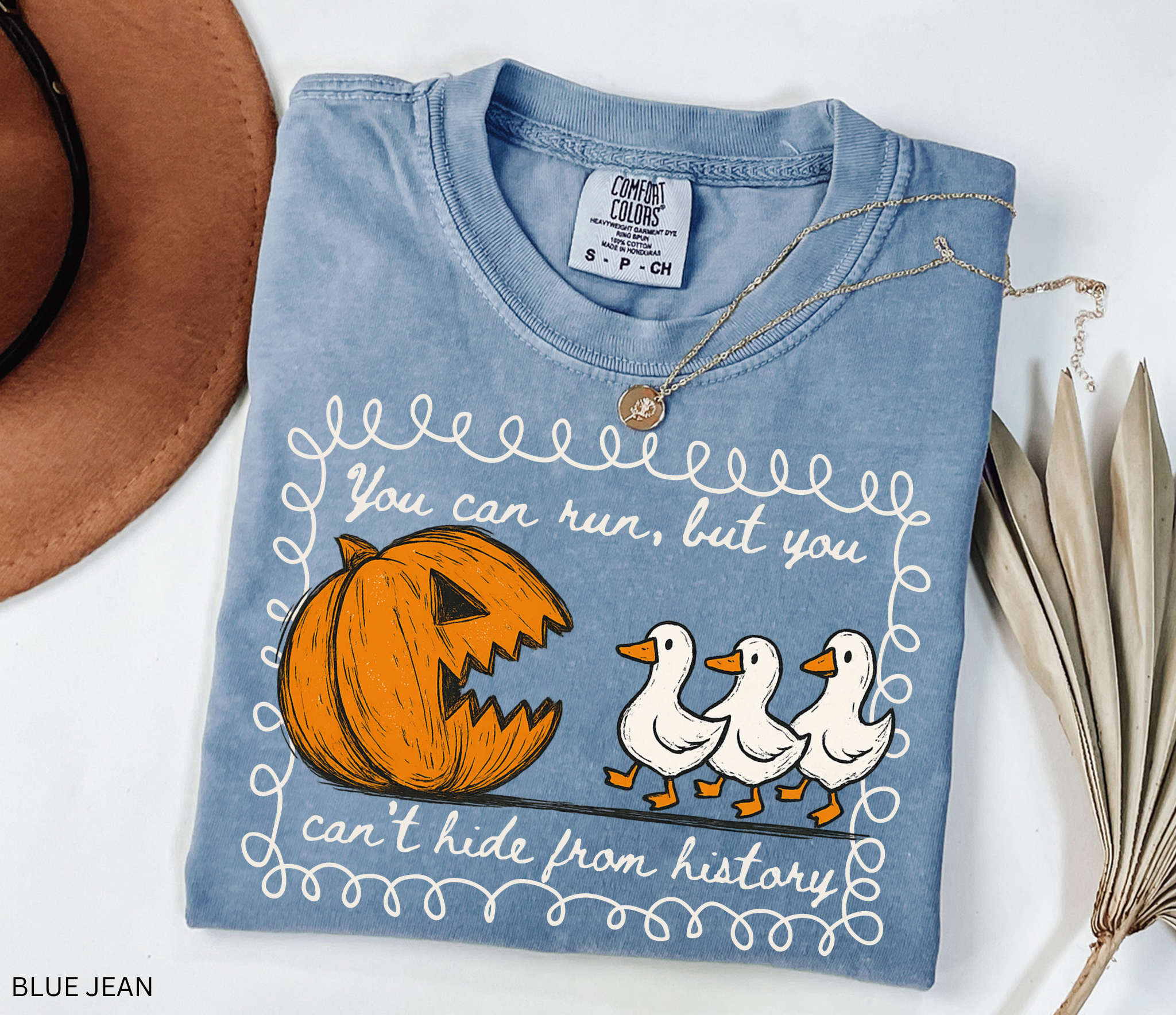 Halloween history teacher shirt with a pumpkin chasing geese and the phrase ‘You can run, but you can’t hide from history.’ Funny spooky season teacher tee