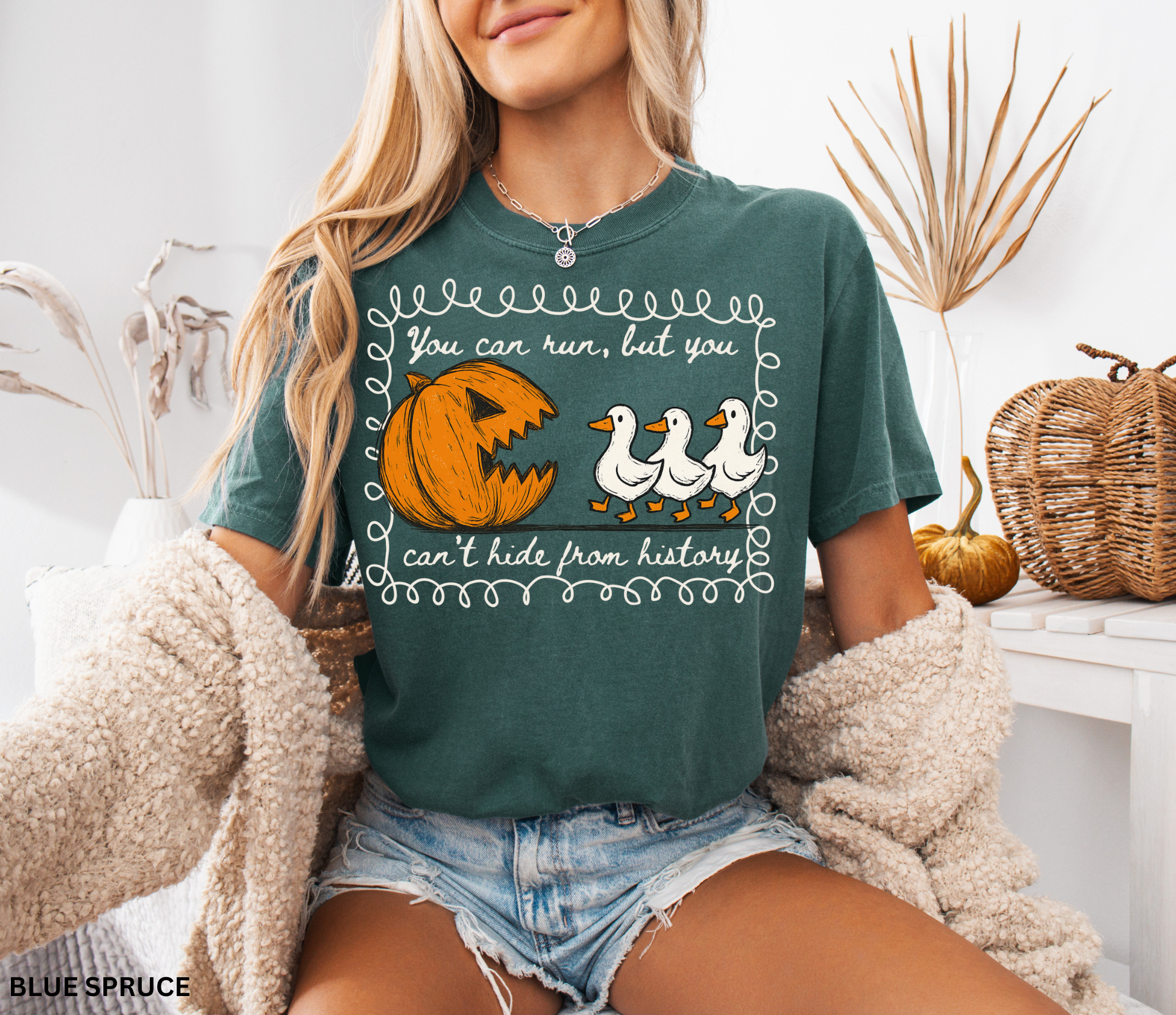 Halloween history teacher shirt with a pumpkin chasing geese and the phrase ‘You can run, but you can’t hide from history.’ Funny spooky season teacher tee