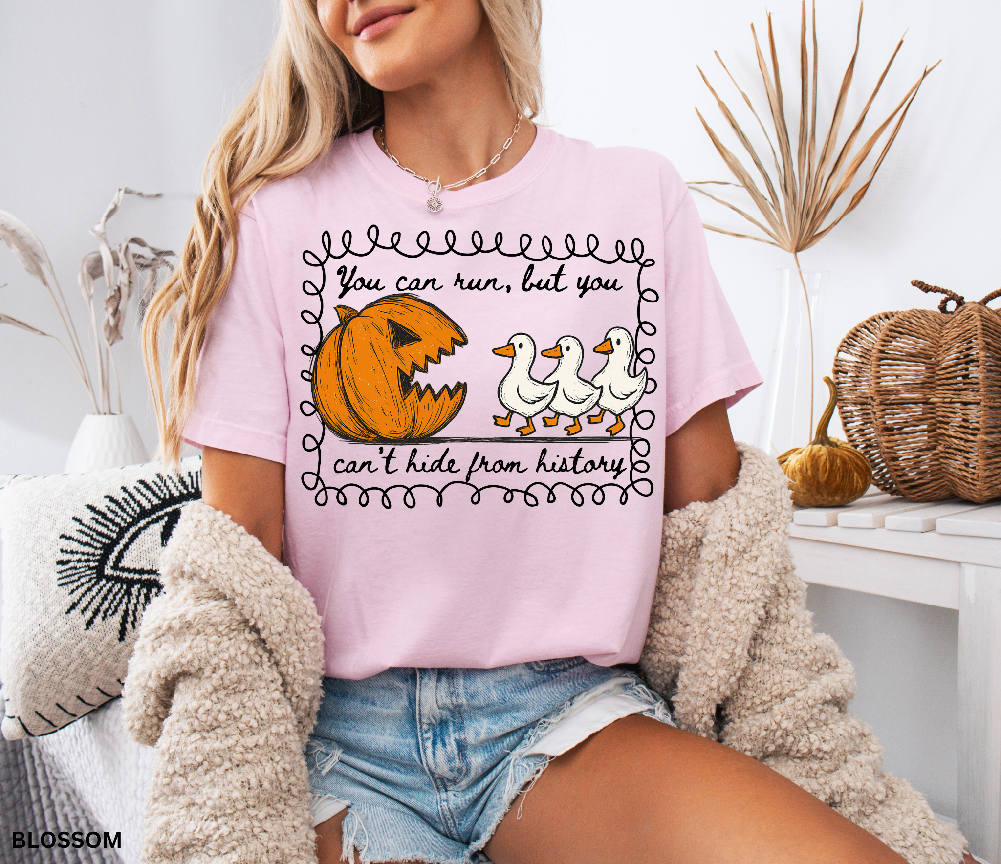 Halloween history teacher shirt with a pumpkin chasing geese and the phrase ‘You can run, but you can’t hide from history.’ Funny spooky season teacher tee